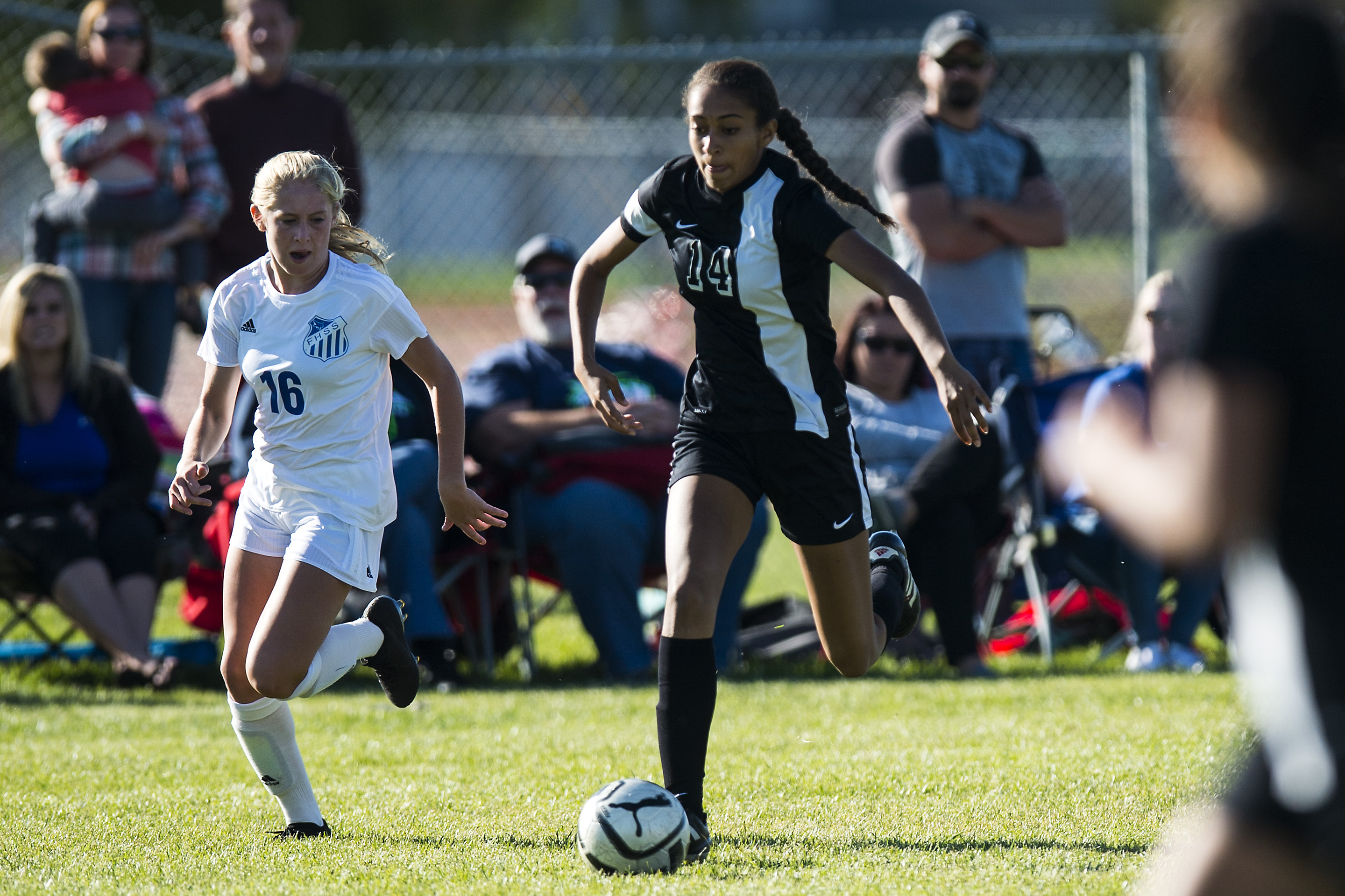 (Chris Detrick | The Salt Lake Tribune) Syracuse's Sarah Wynn (14) runs past Fremont's Brynlee Meyerhoffer (16) during the game at Fremont High School Thursday, October 5, 2017.