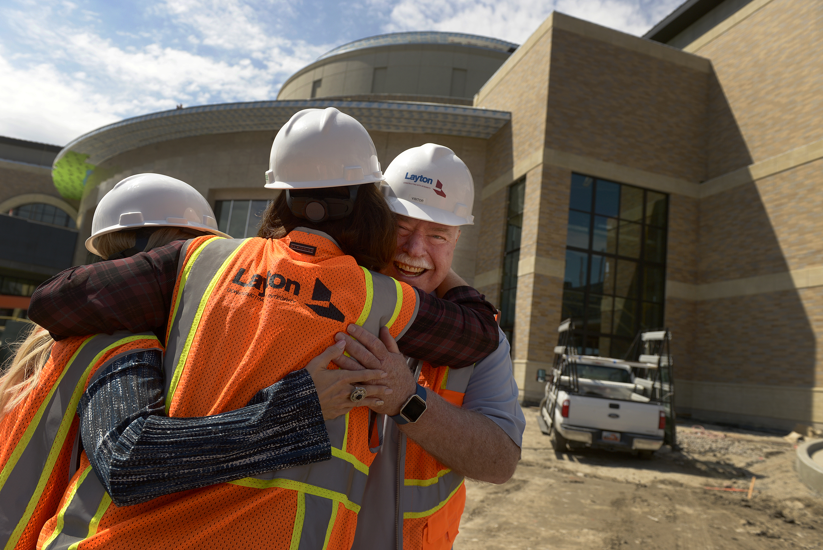 (Leah Hogsten | The Salt Lake Tribune) Sandy City Mayor Tom Dolan laughs as Hale Centre Theatre vice president Sally Dietlein (center) hugs him and Sandy City communications director Nicole Martin (left) on the theatre's construction site. The Mountain American Performing Arts Centre is the new 130,000 square feet home to new Hale Centre Theatre, August 8, 2017.