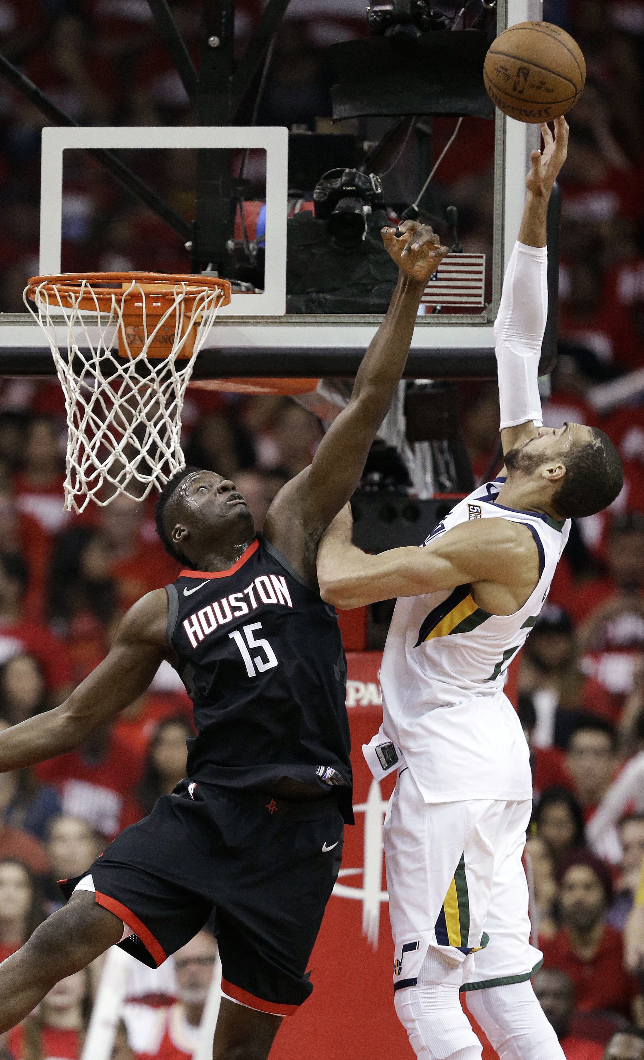 Houston Rockets center Clint Capela (15) and Utah Jazz center Rudy Gobert reach for a pass during the first half in Game 2 of an NBA basketball second-round playoff series, Wednesday, May 2, 2018, in Houston. (AP Photo/Eric Christian Smith)