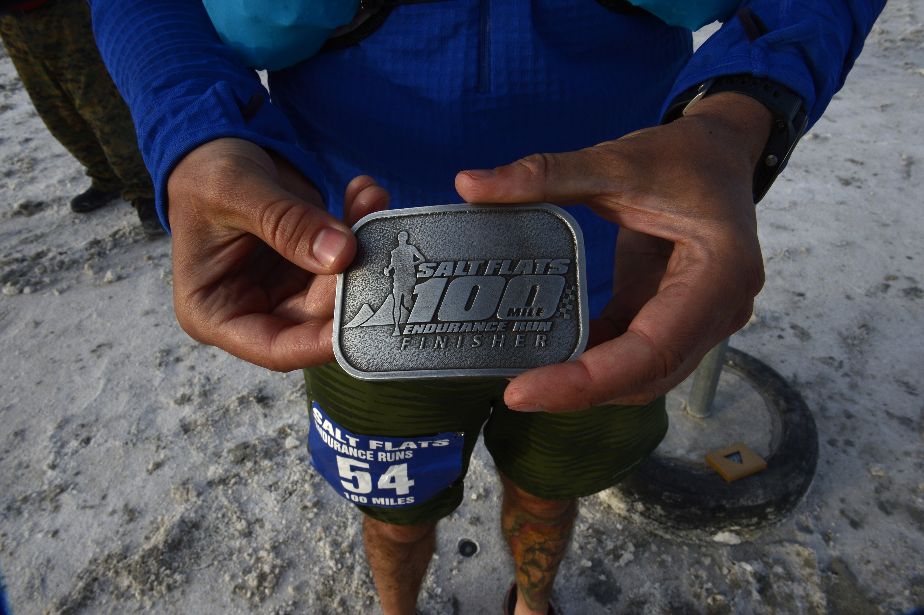 (Scott Sommerdorf | The Salt Lake Tribune) Alex Doolan, shows off the belt buckle he was given for finishing the Salt Flats 100 Endurance Run in 8th place, Saturday, May 5, 2018. 