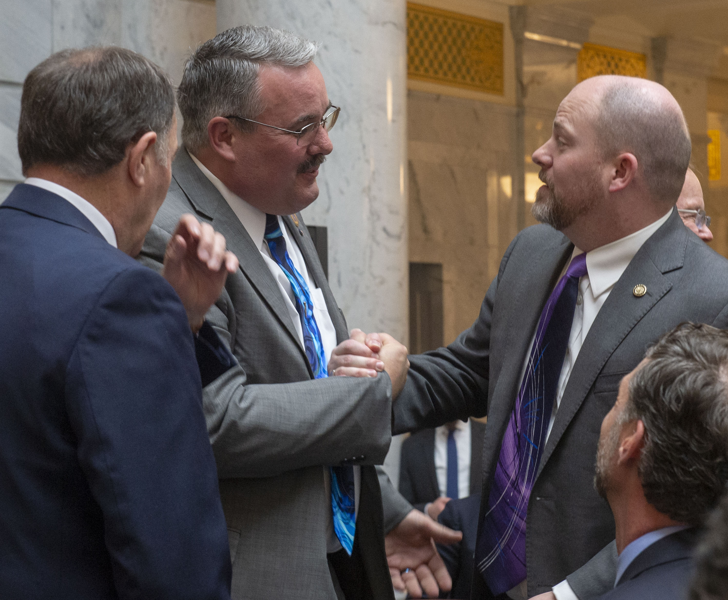 (Rick Egan | The Salt Lake Tribune) Sen. Lee Perry shakes hands with Sen. Daniel Thatcher, after Gov. Gary R. Herbert signed the new hate crimes bill, at the Utah State Capitol, Tuesday, April 2, 2019. 