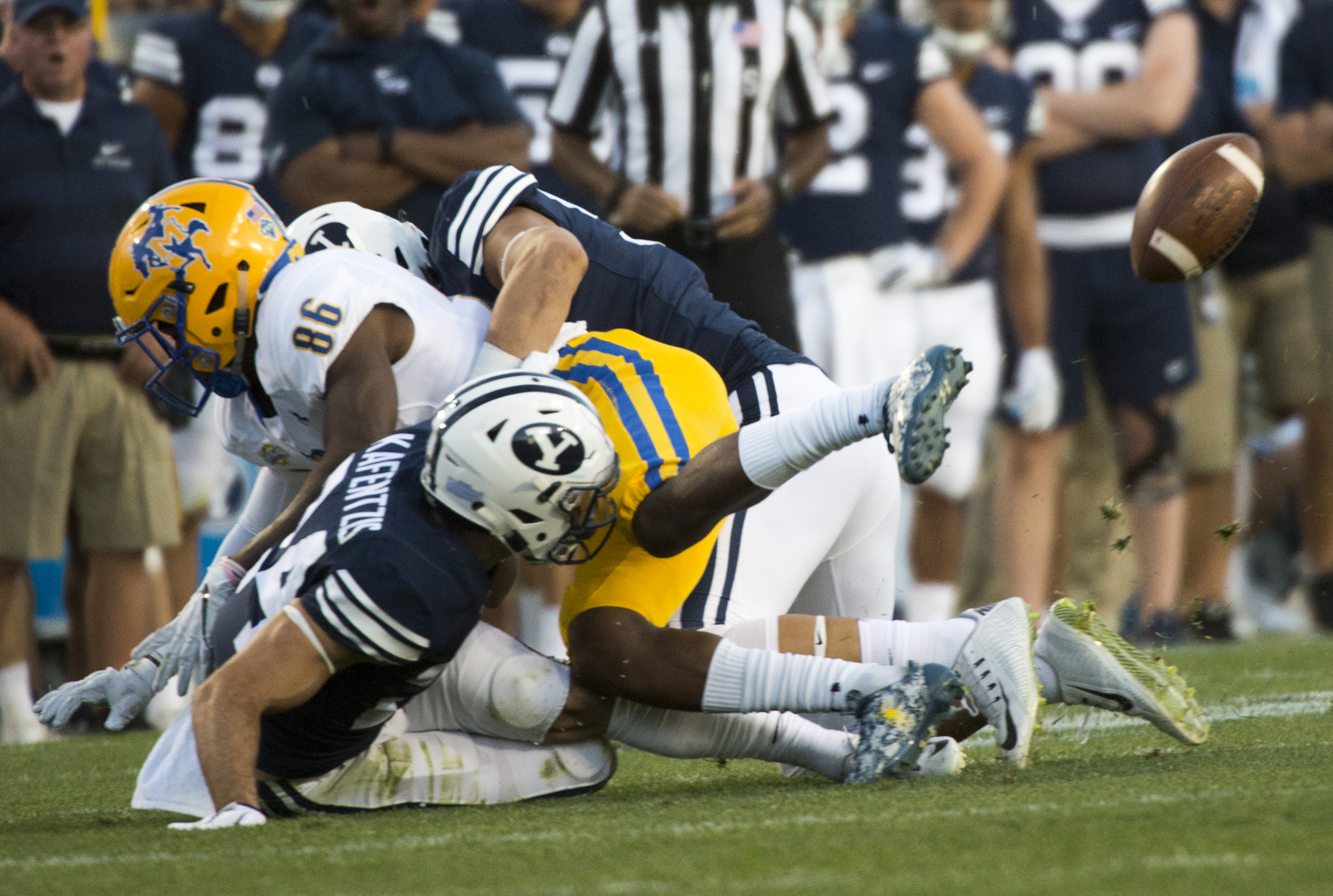 (Rick Egan | The Salt Lake Tribune) Brigham Young Cougars defensive back Austin Kafentzis (24) and linebacker Nate Sampson (50), force a fumble as they hit McNeese State Cowboys wide receiver Rodnell Cruell (86), in football action Brigham Young Cougars vs McNeese State Cowboys at Lavell Edwards Stadium, Saturday, Sept. 22, 2018. 