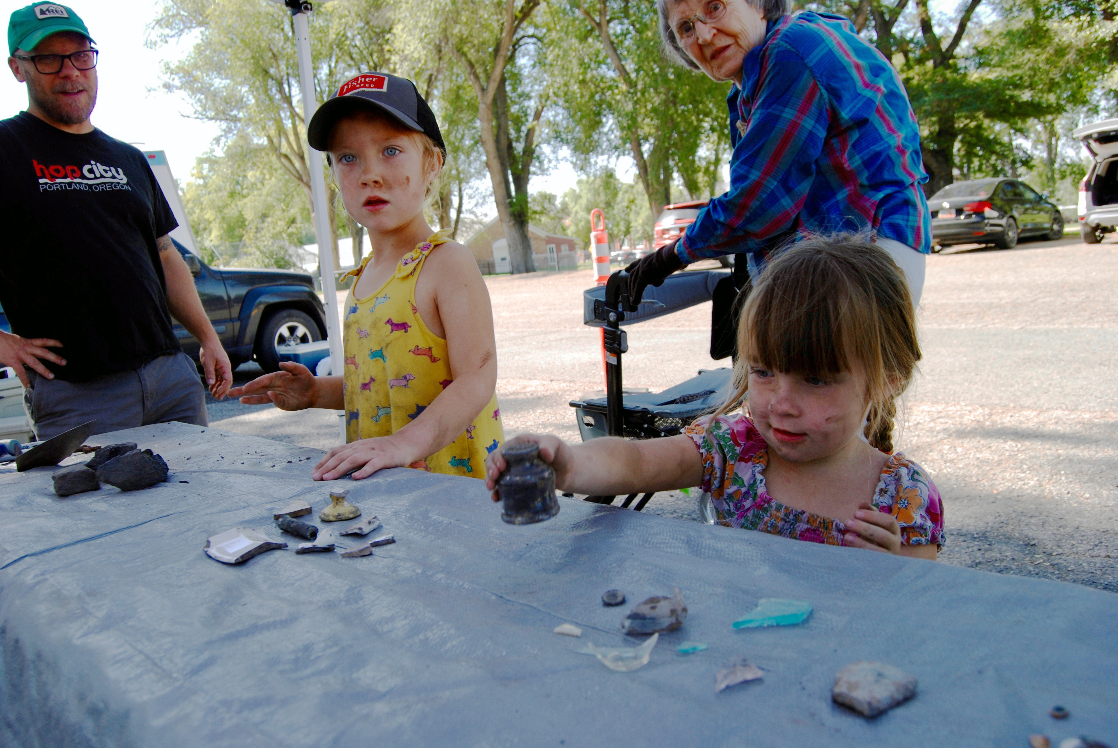 (Brian Maffly | The Salt Lake Tribune) Teagan Miller, right, and sister Nina examine an intact ink bottle discovered Saturday during a public archaeological event at Fort Douglas Military Museum in Salt Lake City on Saturday, Sept. 22, 2018. 