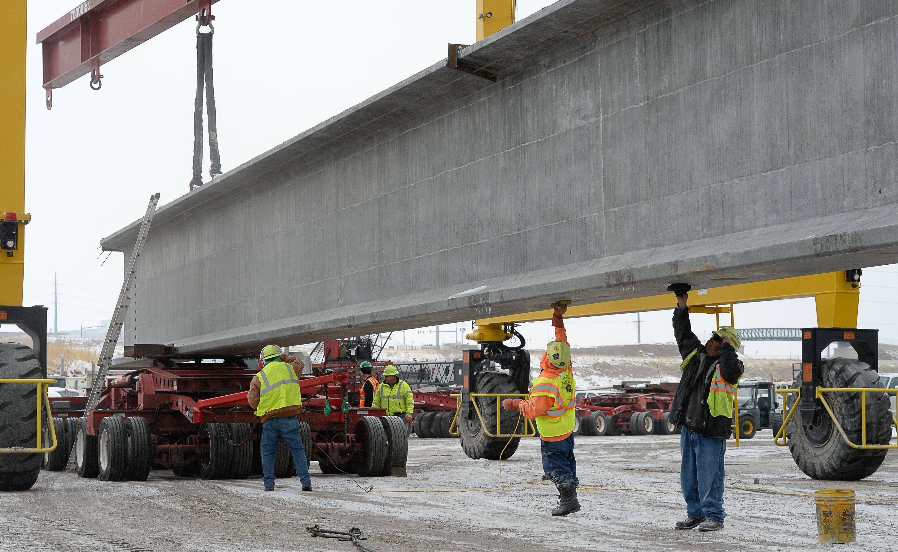 (Francisco Kjolseth | The Salt Lake Tribune) UDOT gets ready to place some of the world's largest-ever bridge beams, and the largest in Utah state history with a span of 203 ft long and just over 8 ft tall, as crews load one on a truck following manufacturing at Forterra Structural Precast in Kearns on Tuesday, Dec. 11, 2018. A total of six beams will be installed in the technology corridor in Lehi later this week.