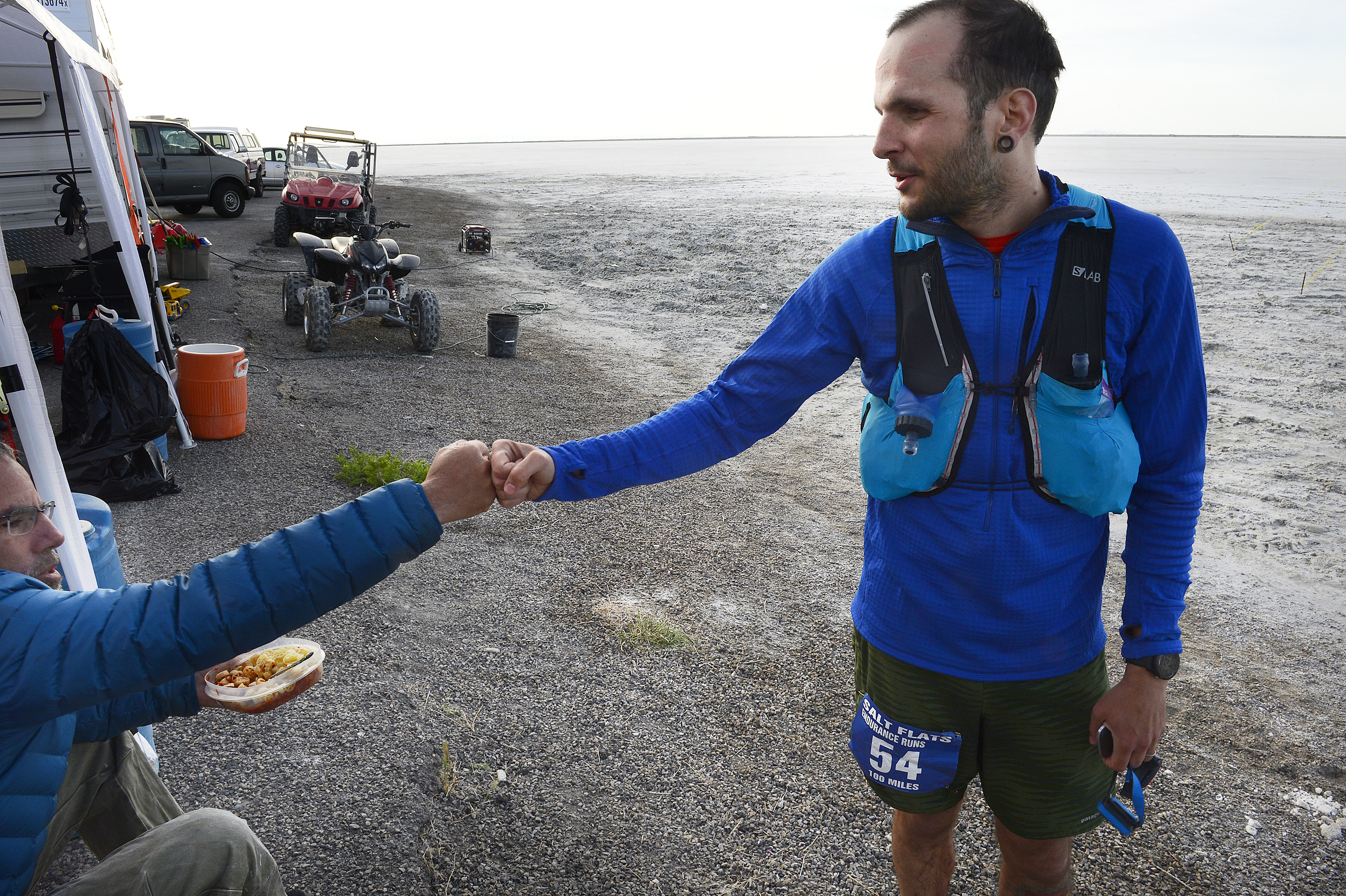 (Scott Sommerdorf | The Salt Lake Tribune) Fellow runner Todd Vogel, left, congratulates Alex Doolan after Doolan finished the Salt Flats 100 Endurance Run, Saturday, May 5, 2018. 