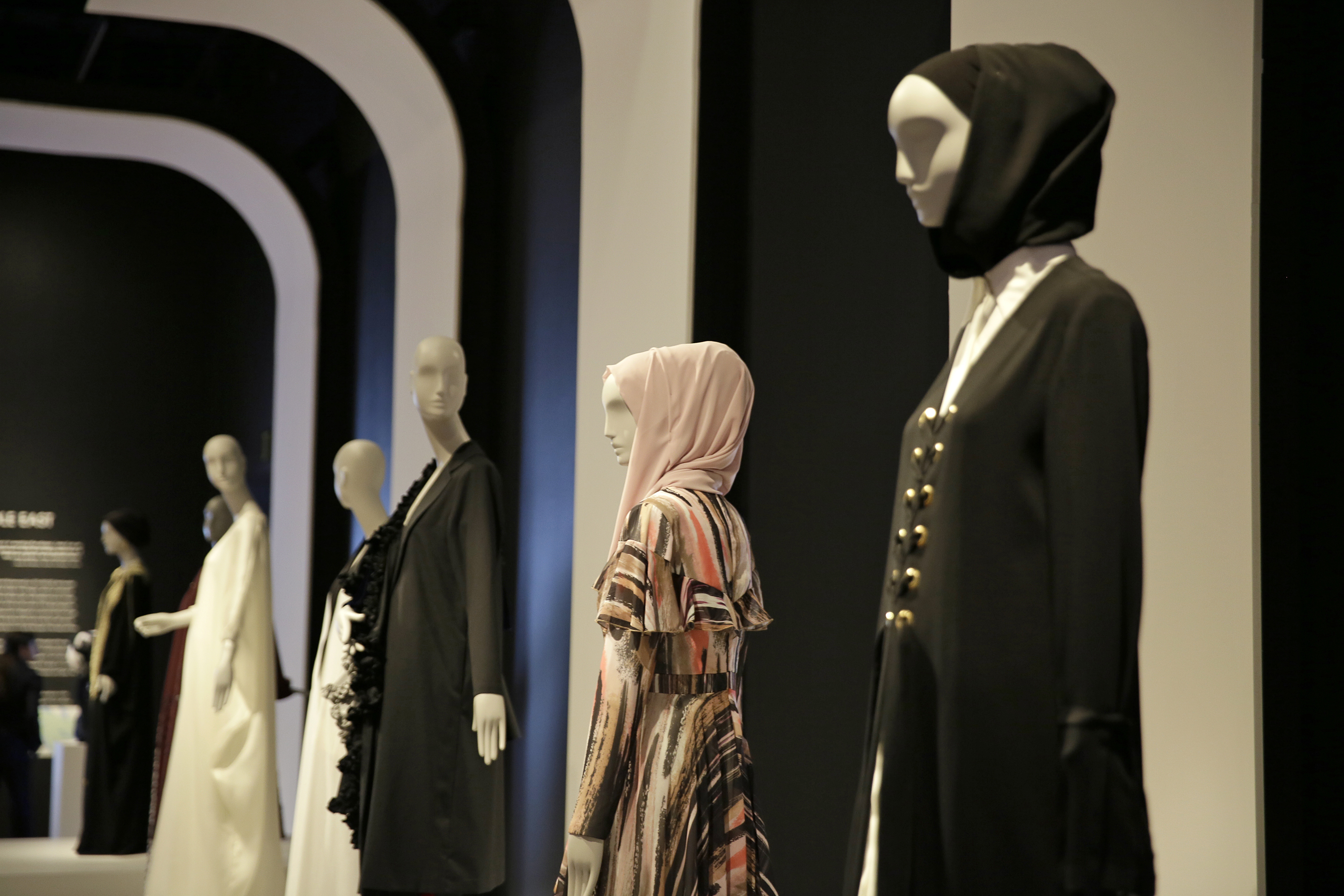 In this photo taken Thursday, Sept. 20, 2018, a number of headscarves and ensembles are seen in the exhibit Contemporary Muslim Fashions at the M. H. de Young Memorial Museum in San Francisco. The first major museum exhibition of contemporary Muslim women's fashion reflects designs from around the world that are vibrant and elegant, playful and diverse. The show's creators hope the exhibit will show Muslim women as real people who can choose what they wear rather than as subjects ordered to cover their entire bodies or restricted in what they can wear. The exhibit opens on Saturday. (AP Photo/Eric Risberg)