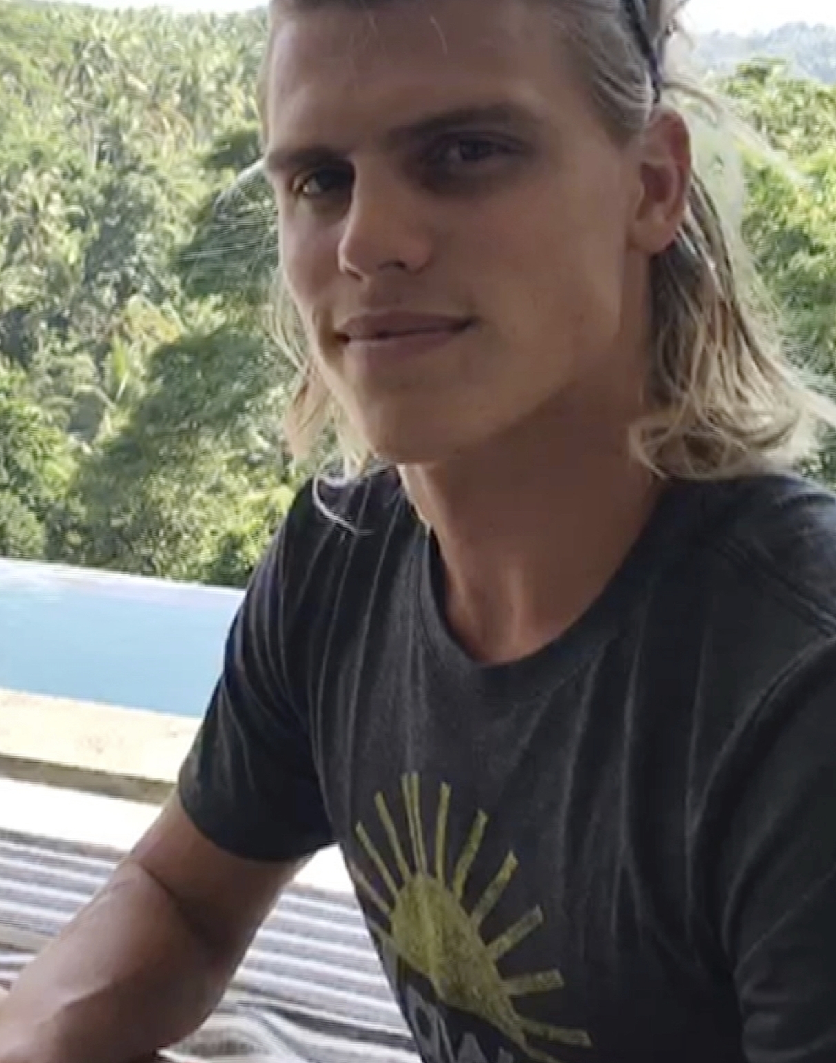 In this July 23, 2018, image made from video, Koa Smith, while in Bali, Indonesia, talks about his two-minute journey on a surfboard off the coast of Africa. Smith rode a wave for nearly a mile and stayed upright as he traveled through eight barrels--the hollow formed by the curve of the wave as it breaks over the surfer's head. (Koa Smith via AP)