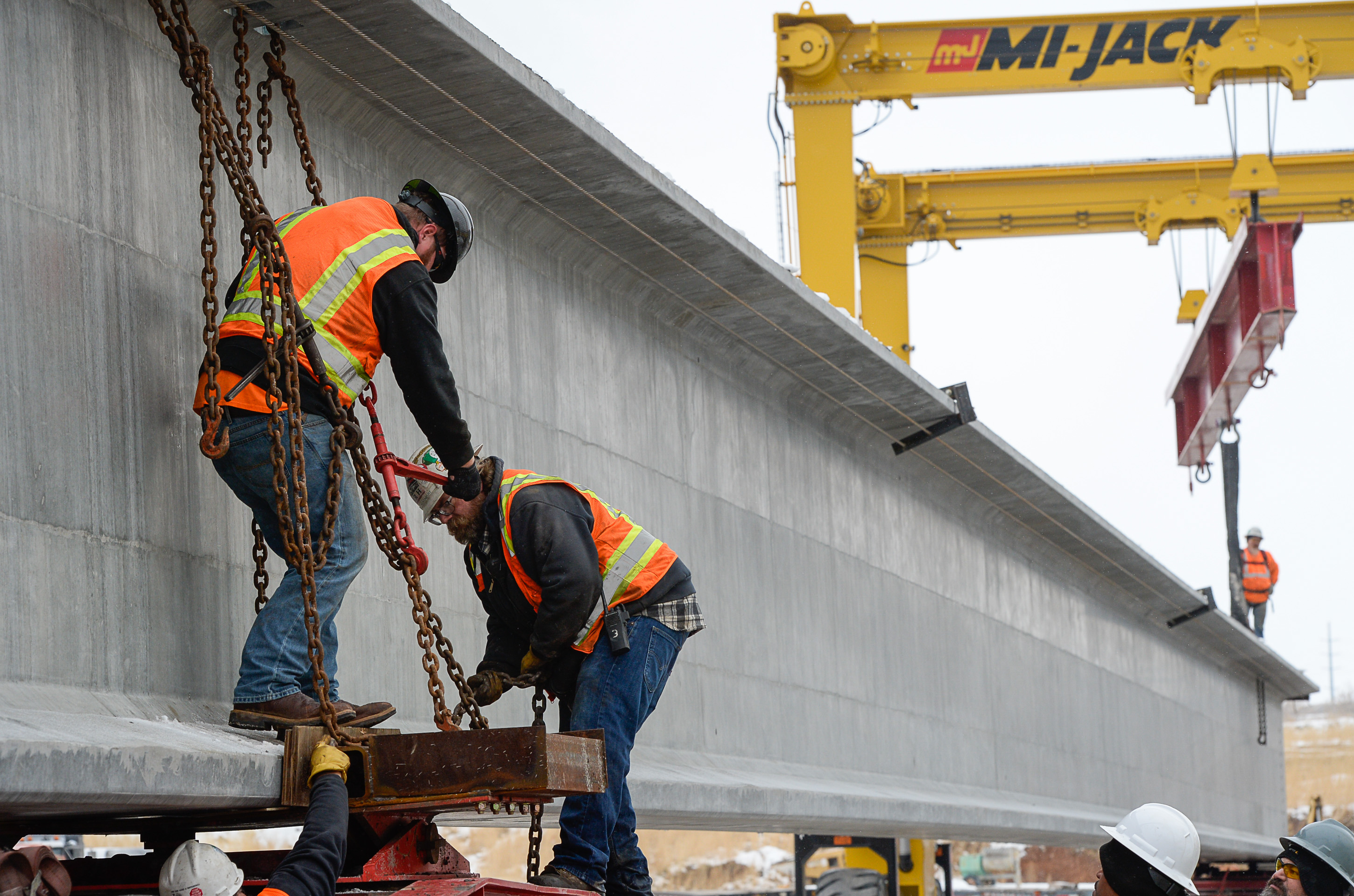 (Francisco Kjolseth | The Salt Lake Tribune) UDOT gets ready to place some of the world's largest-ever bridge beams, and the largest in Utah state history with a span of 203 ft long and just over 8 ft tall, as crews load one on a truck following manufacturing at Forterra Structural Precast in Kearns on Tuesday, Dec. 11, 2018. A total of six beams will be installed in the technology corridor in Lehi later this week.