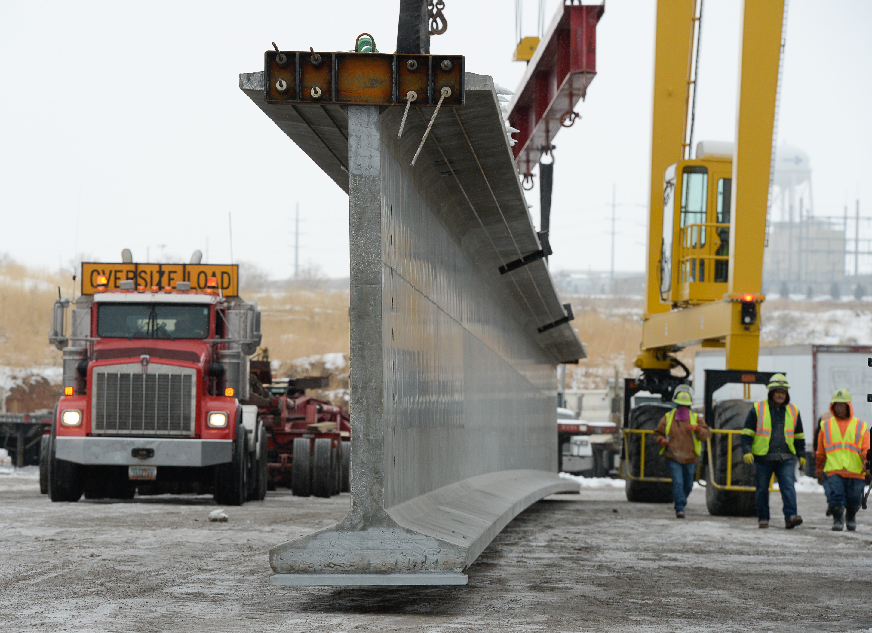 (Francisco Kjolseth | The Salt Lake Tribune) UDOT gets ready to place some of the world's largest-ever bridge beams, and the largest in Utah state history with a span of 203 ft long and just over 8 ft tall, as crews load one on a truck following manufacturing at Forterra Structural Precast in Kearns on Tuesday, Dec. 11, 2018. A total of six beams will be installed in the technology corridor in Lehi later this week.