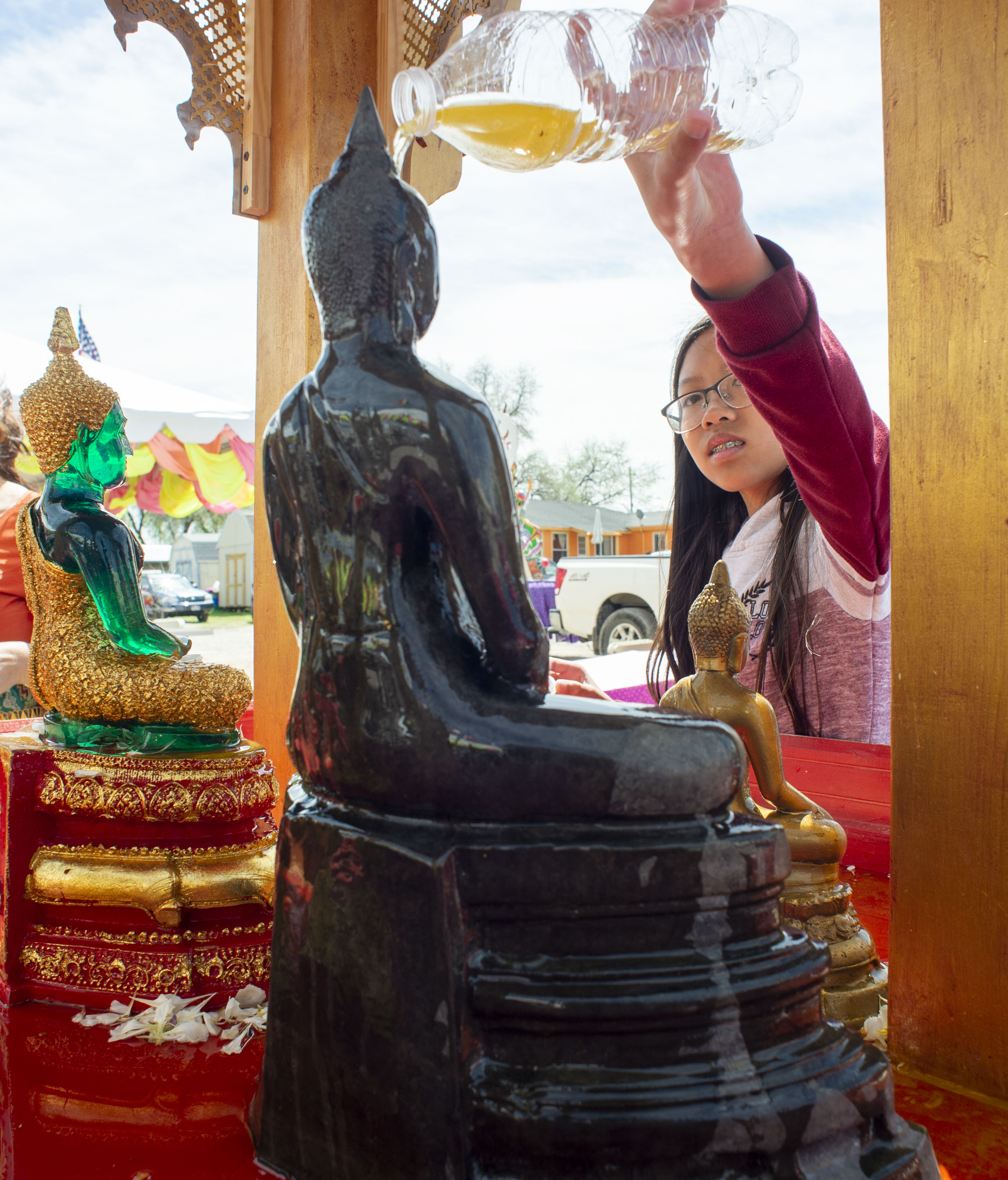 (Rick Egan | The Salt Lake Tribune) Menna Tren pours holy water over the Buddha, at the Wat Lao Salt Lake Buddharam Utah, New Year Celebration, in West Valley City, Sunday, April 28, 2019. 
