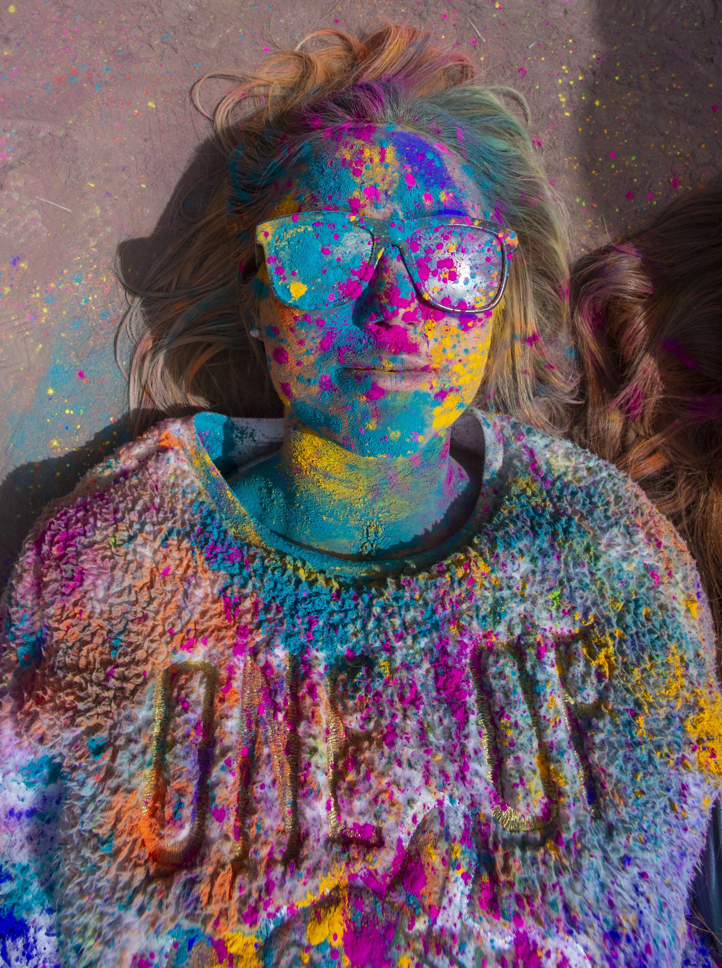 (Rick Egan | The Salt Lake Tribune) Kimberly Woolsey, from Gilbert , Arizona, takes a break from the crowd and lies not the ground, during the Holi Festival of Colors celebration at the Sri Sri Radha Krishna Temple in Spanish Fork, Saturday, March 30, 2019. 