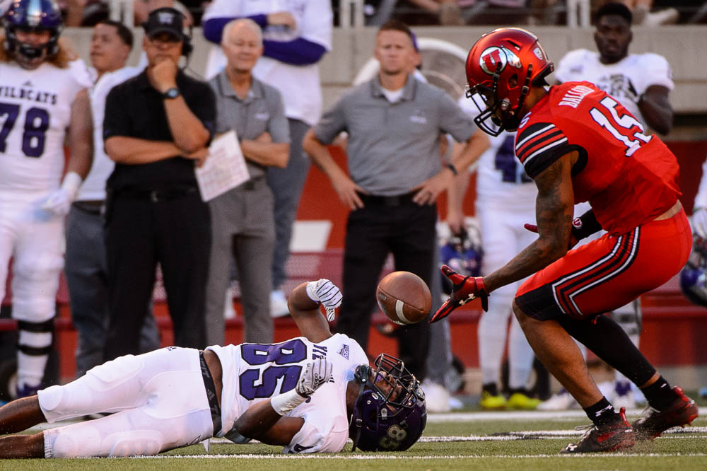 (Trent Nelson | The Salt Lake Tribune) Weber State Wildcats wide receiver Devon Cooley (85) loses the ball as the University of Utah Utes host the Weber State Wildcats, Thursday Aug. 30, 2018 at Rice-Eccles Stadium in Salt Lake City. At right is Utah Utes defensive back Corrion Ballard (15).