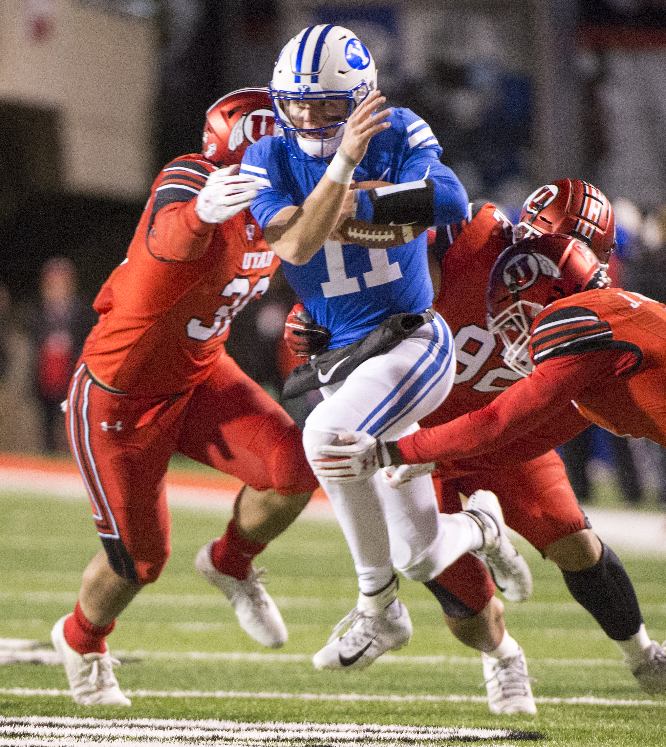 (Rick Egan | The Salt Lake Tribune) Brigham Young Cougars quarterback Zach Wilson (11) drags three Utte defenders with him, as he runs the ball for the Cougars, in football action between the Brigham Young Cougars and the Utah Utes, at Rice-Eccles Stadium, Saturday, November 24, 2018. 