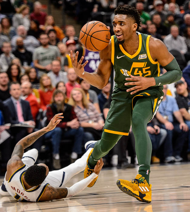 (Trent Nelson | The Salt Lake Tribune) Utah Jazz guard Donovan Mitchell (45) is fouled by Denver Nuggets guard Monte Morris (11) as the Utah Jazz host the Denver Nuggets, NBA basketball in Salt Lake City on Wednesday Jan. 23, 2019.