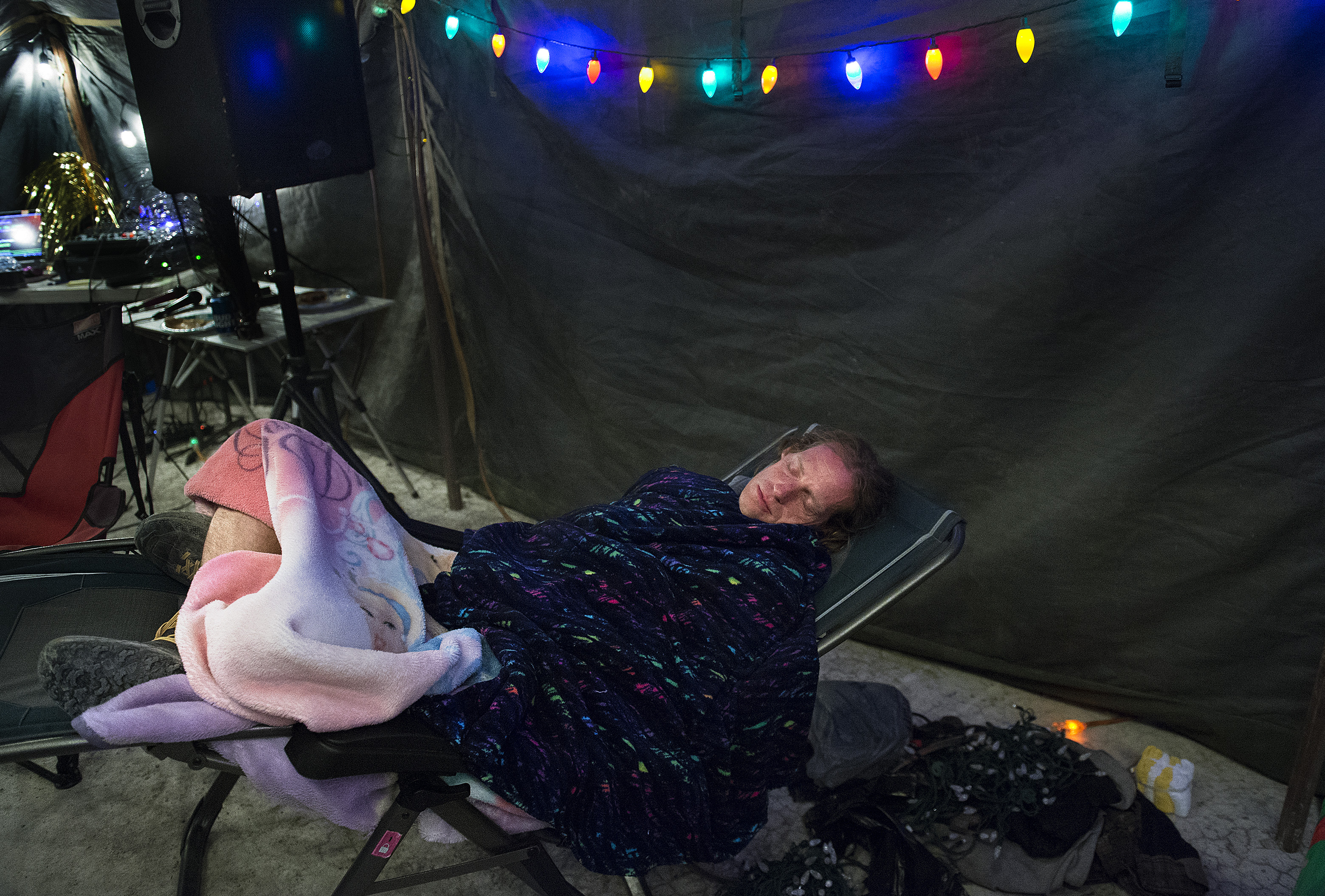 (Scott Sommerdorf | The Salt Lake Tribune) Matt Van Horn, the winner of the Salt Flats 100 Endurance Run sleeps at 6 a.m. in Aid Station 14, Saturday, May 5, 2018. Van Horn finished the race at around 1 a.m., and was so full of energy, he immediately sang a round of karaoke with volunteers at the checkpoint. 
