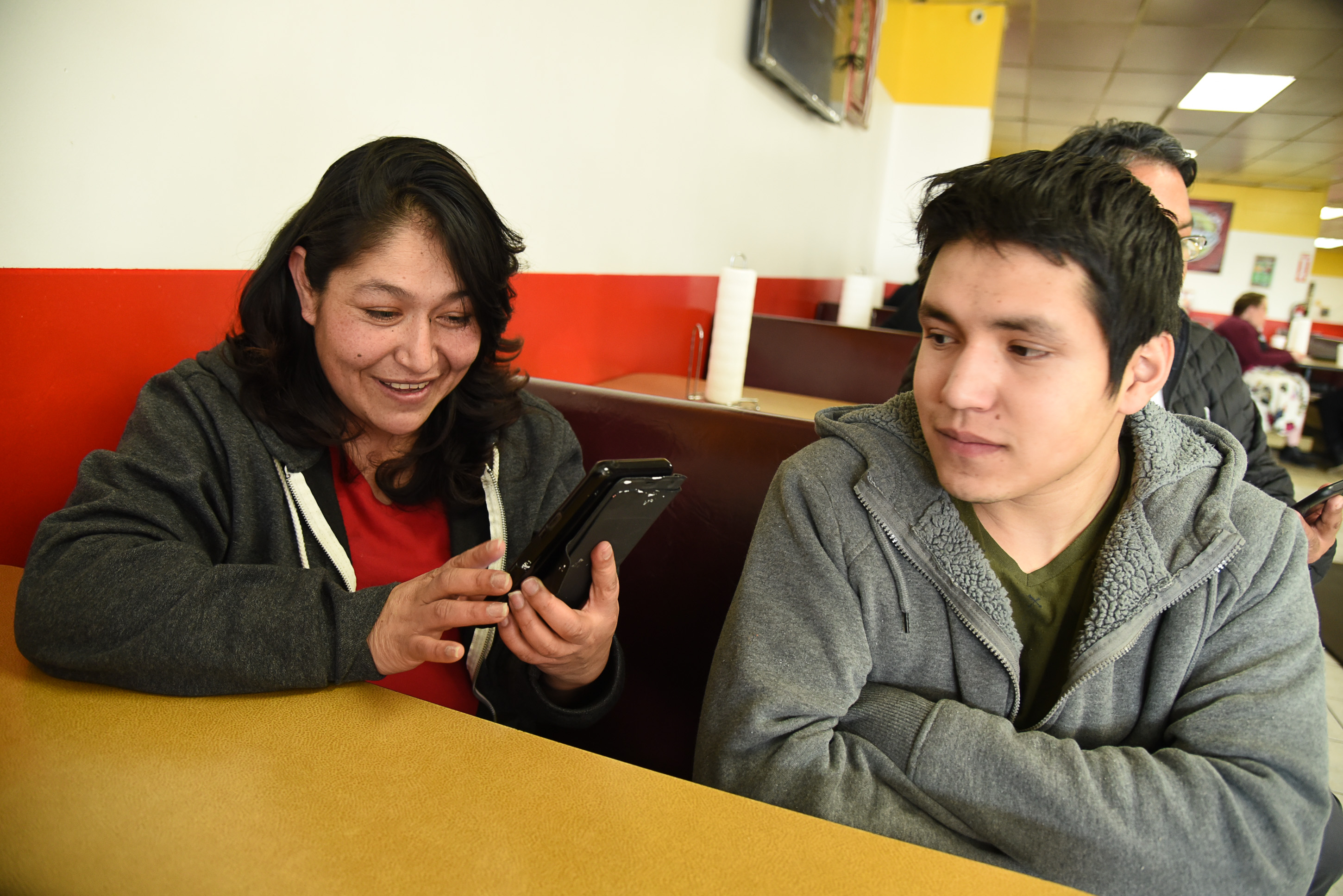 (Francisco Kjolseth | The Salt Lake Tribune) Carolina Marquez looks up photos of her late husband Adrian De Los Santos Luna during the early days of their taco business back in 2015. Alongside her son Adrian who has had to step up his involvement in the family business, it has been hard on the kids since his dad committed suicide just before Christmas last year. Tacos Mi Caramelo, a late-night taqueria that is open until 2 a.m. most nights and 24-hours a day on Friday and Saturday.