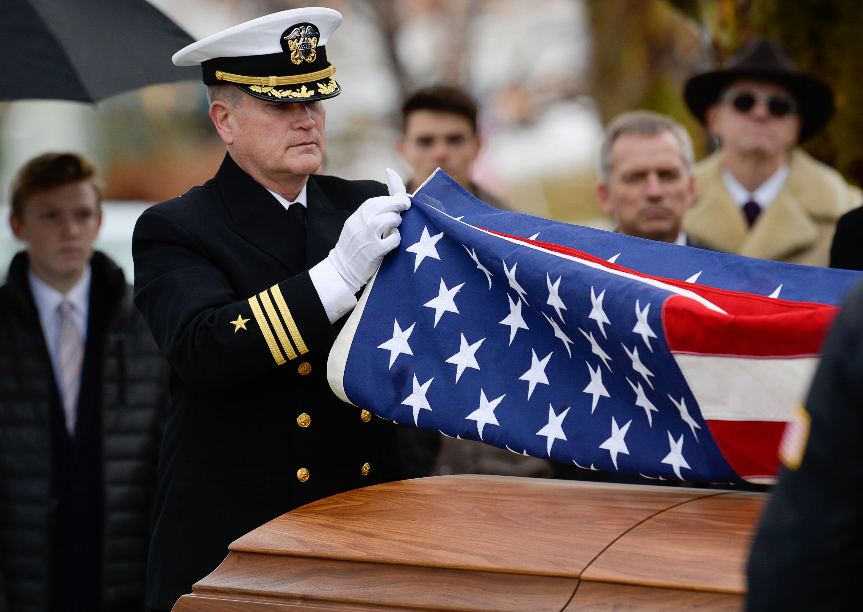 (Francisco Kjolseth | The Salt Lake Tribune) Commander Cory Baggs folds the flag draping former congressman Jim Hansen's casket at Farmington City Cemetery, Saturday, Nov. 24, 2018.