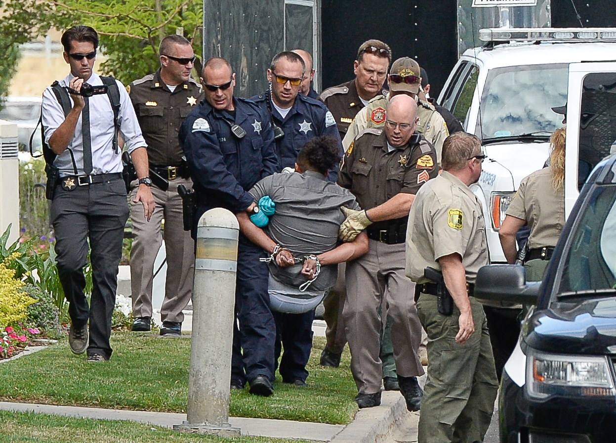 (Francisco Kjolseth | The Salt Lake Tribune) Activists are escorted out of a building where they staged a protest against a private prison company with contracts to hold undocumented immigrants on Thursday, July 12, 2018, at the headquarters of Management and Training Corporation in Centerville.