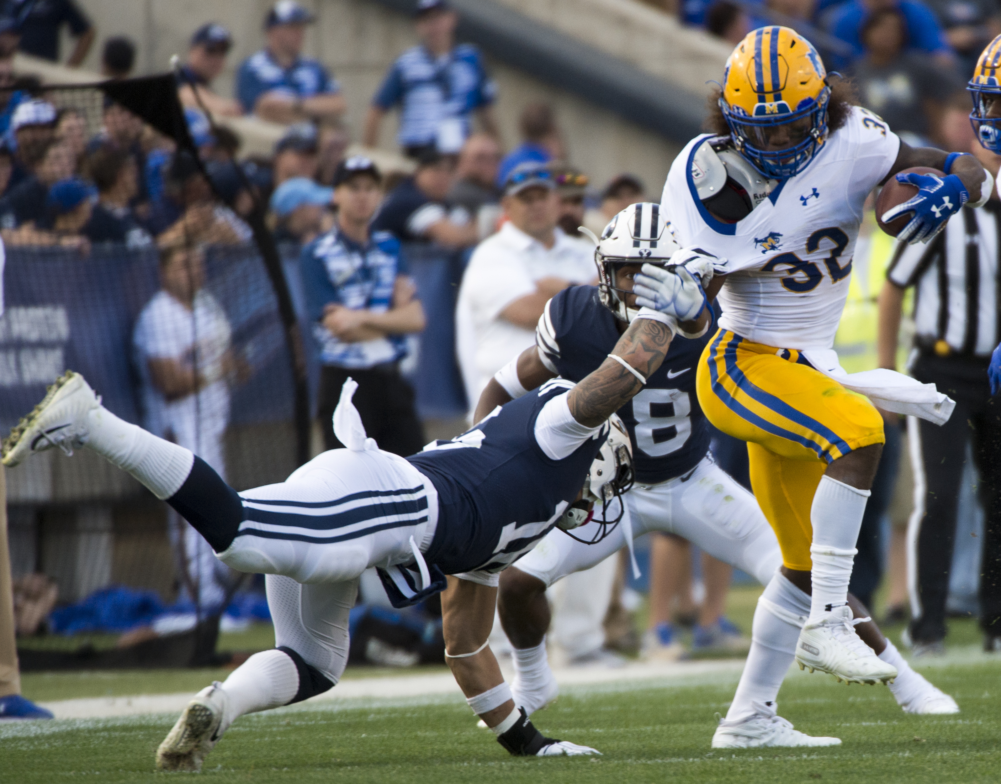 (Rick Egan | The Salt Lake Tribune) Brigham Young Cougars linebacker Sione Takitaki (16) gets his hands on McNeese State Cowboys running back David Hamm (32), in football action Brigham Young Cougars vs McNeese State Cowboys at Lavell Edwards Stadium, Saturday, Sept. 22, 2018. 