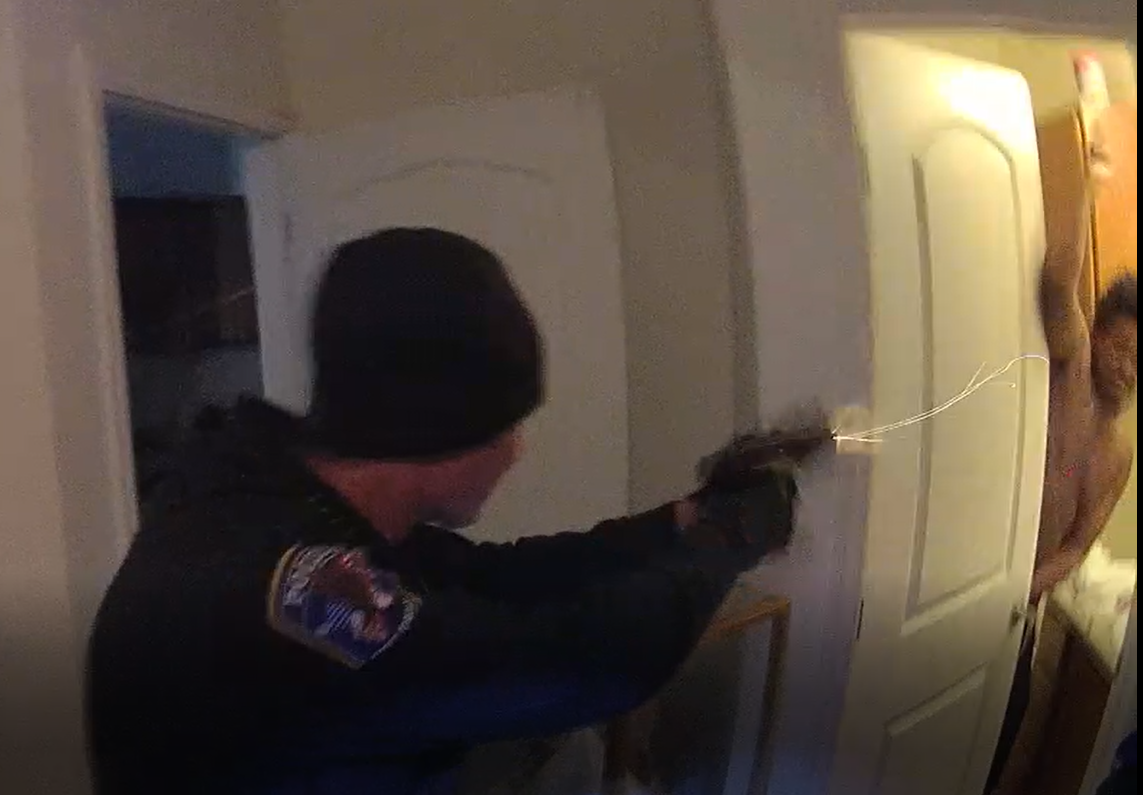(Photo courtesy of the Salt Lake County District Attorney's Office.) West Jordan police officer Brian White fires a shot at Diamonte Riviore as Riviore raises a knife over his head. Riviore was shot twice in the torso and died Oct. 11, 2018. Salt Lake County Attorney Sim Gill ruled that the shooting was justified.