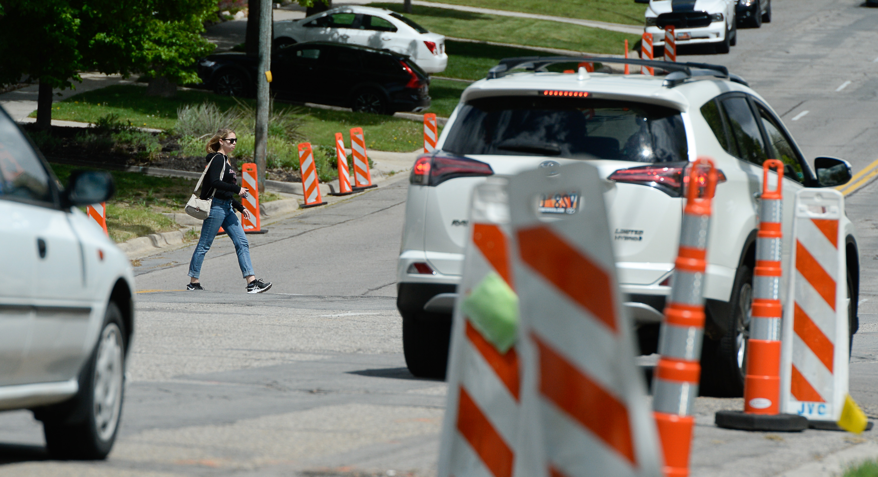 (Francisco Kjolseth | The Salt Lake Tribune) Traffic moves along a sea of orange as plans to repurpose 29 parking spaces between 950 East and 1300 East on 900 South in Salt Lake City causes some frustration from business owners and residents in the area.