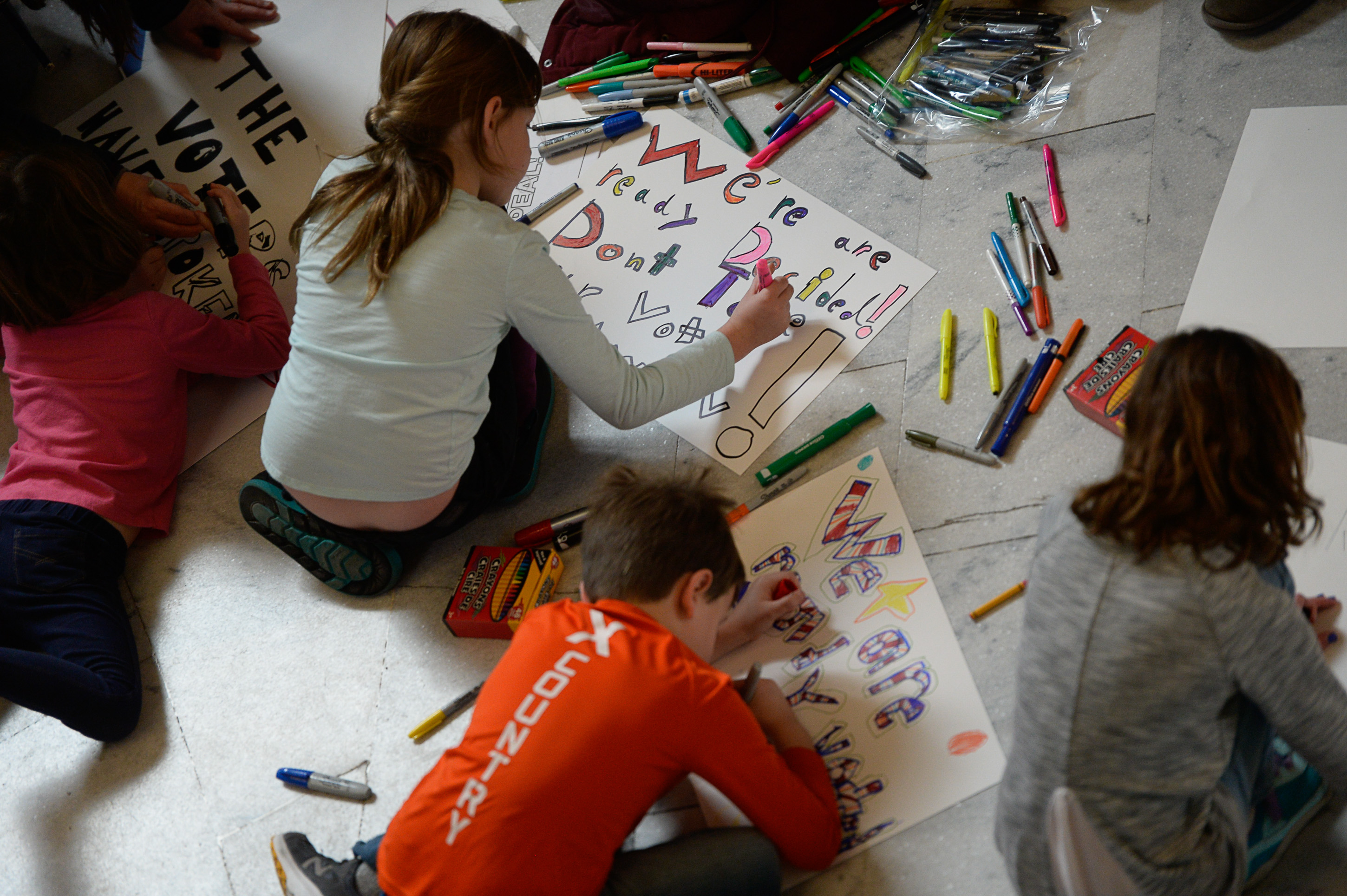 (Francisco Kjolseth | The Salt Lake Tribune) Kids help to make signs in the Capitol rotunda on Monday, Jan, 28, 2019, on the first day of the Legislative session to rally in support of protecting Proposition 3, the Medicaid Expansion law recently passed by voters.