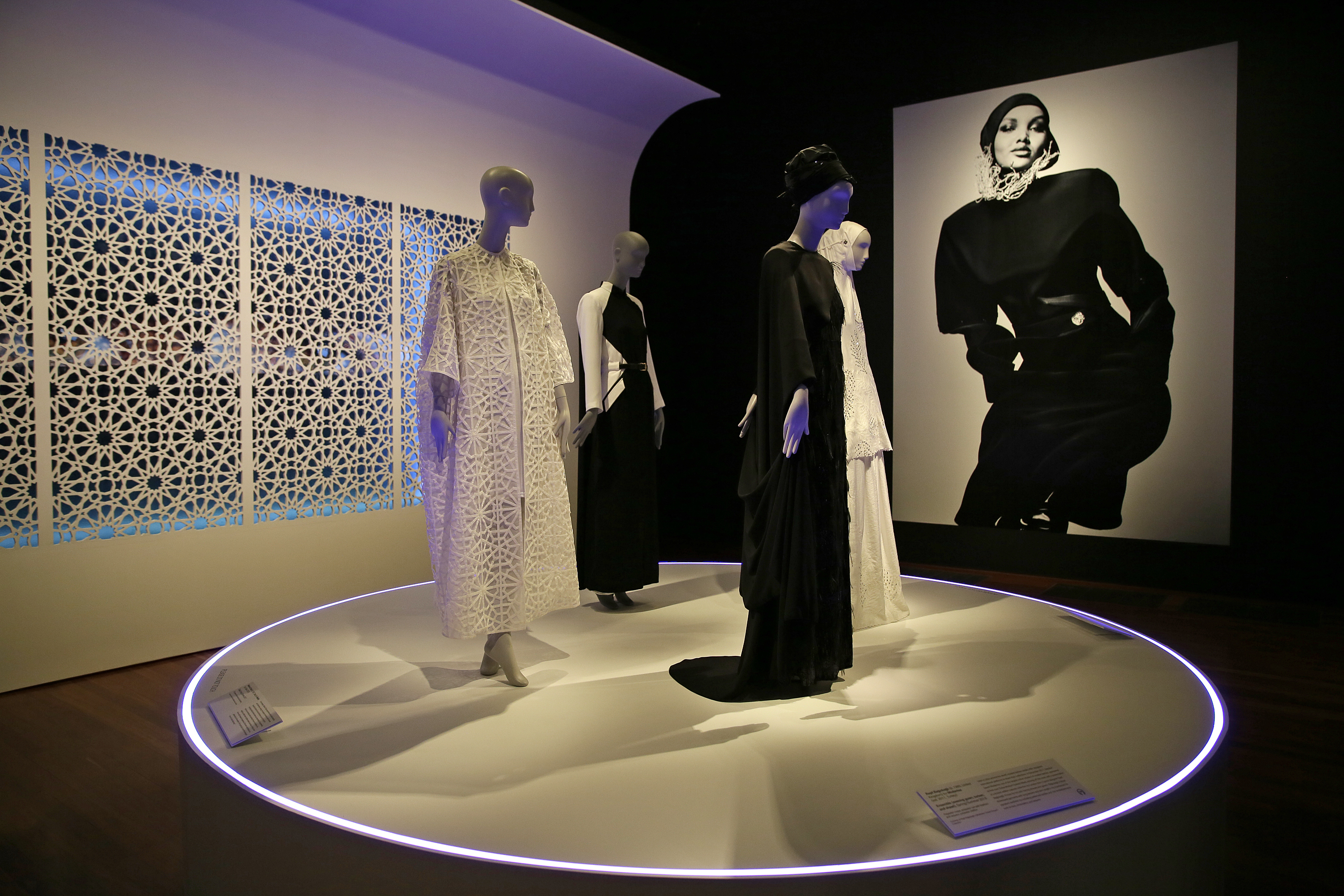 (Eric Risberg | AP Photo) In this photo taken Thursday, Sept. 20, 2018, praying ensembles and dresses are displayed in the exhibit Contemporary Muslim Fashions at the M. H. de Young Memorial Museum in San Francisco. The first major museum exhibition of contemporary Muslim women's fashion reflects designs from around the world that are vibrant and elegant, playful and diverse. The show's creators hope the exhibit will show Muslim women as real people who can choose what they wear rather than as subjects ordered to cover their entire bodies or restricted in what they can wear. The exhibit opens on Saturday.
