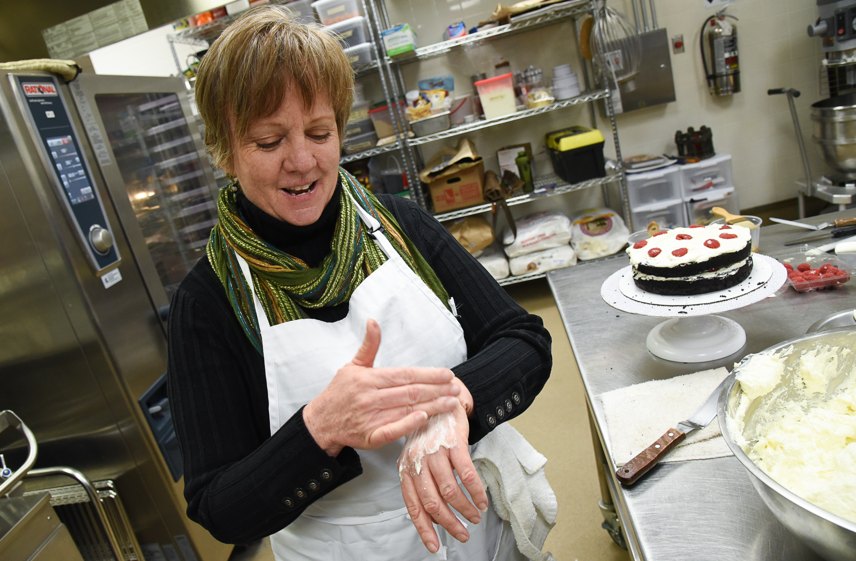 (Francisco Kjolseth | The Salt Lake Tribune) Actress Betsy West prepares for an upcoming role of a Southern Baptist bakery owner in North Carolina faced with a request to bake a cake for a gay couple getting married for Salt Lake Acting Company's production of "The Cake." Thinking about a scene in which she tries to seduce her husband that doesn't go so well, West spreads Italian butter cream on her hand to get a better sense of texture.