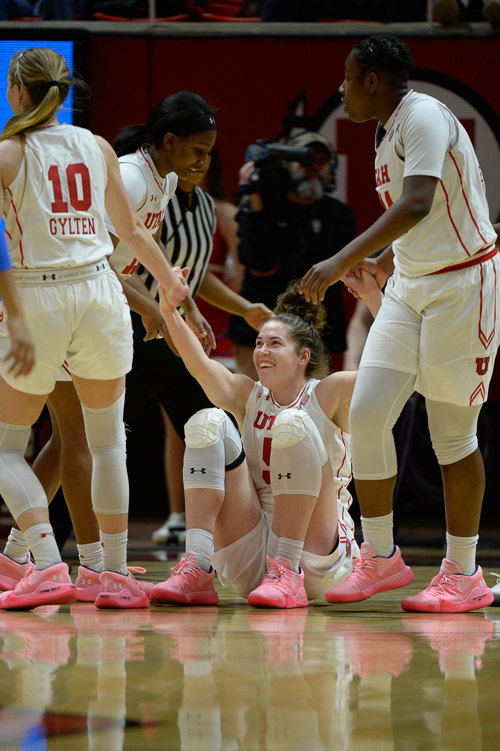 (Francisco Kjolseth | The Salt Lake Tribune) Utah Utes forward Megan Huff (5) is helped up by teammates after a hard hit by the UCLA defense at the Jon M. Huntsman Center in Salt Lake City on Sunday, Feb. 10, 2019.