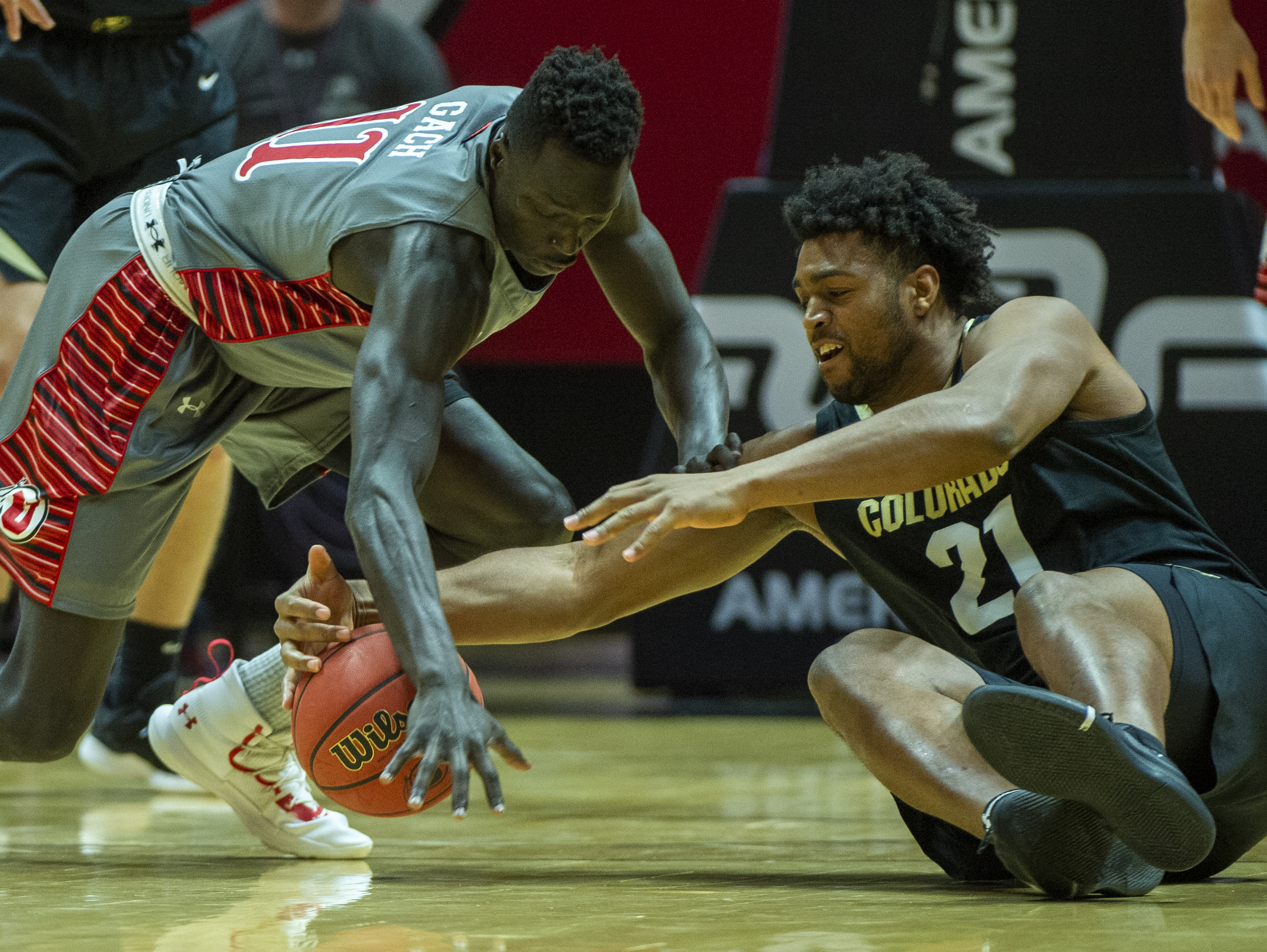 (Rick Egan | The Salt Lake Tribune) Utah Utes forward Both Gach (11) goes for a loose ball along with Colorado Buffaloes forward Evan Battey (21), in PAC-12 basketball action between the Utah Utes and the Colorado Buffaloes at the Jon M. Huntsman Center, Sunday, Jan. 20, 2019. 