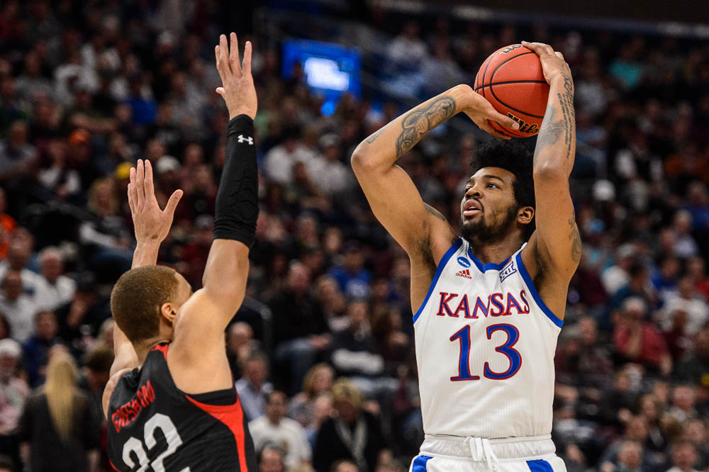 (Trent Nelson | The Salt Lake Tribune) Kansas Jayhawks guard K.J. Lawson (13) shoots over Northeastern Huskies guard Donnell Gresham Jr. (22) as Kansas faces Northeastern in the 2019 NCAA Tournament in Salt Lake City on Thursday March 21, 2019.