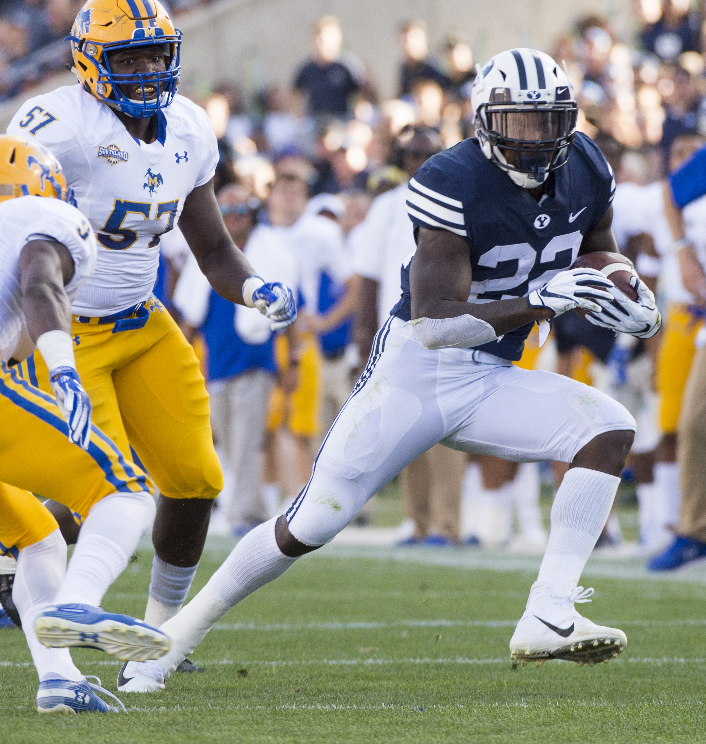 (Rick Egan | The Salt Lake Tribune) Brigham Young Cougars running back Squally Canada (22) gets past McNeese State Cowboys defensive lineman Cody Roscoe (57) and McNeese State Cowboys defensive back Trent Jackson (9), in football action Brigham Young Cougars vs McNeese State Cowboys at Lavell Edwards Stadium, Saturday, Sept. 22, 2018. 