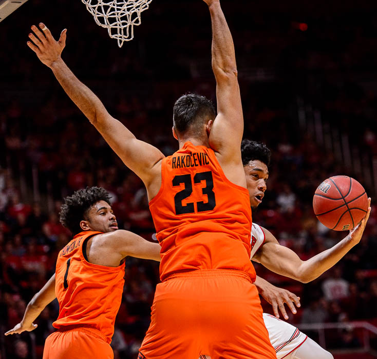 (Trent Nelson | The Salt Lake Tribune) Utah Utes guard Sedrick Barefield (2) drives around Oregon State Beavers center Gligorije Rakocevic (23) as Utah hosts Oregon State, NCAA basketball in Salt Lake City on Saturday Feb. 2, 2019. At left is Oregon State Beavers guard Stephen Thompson Jr. (1).