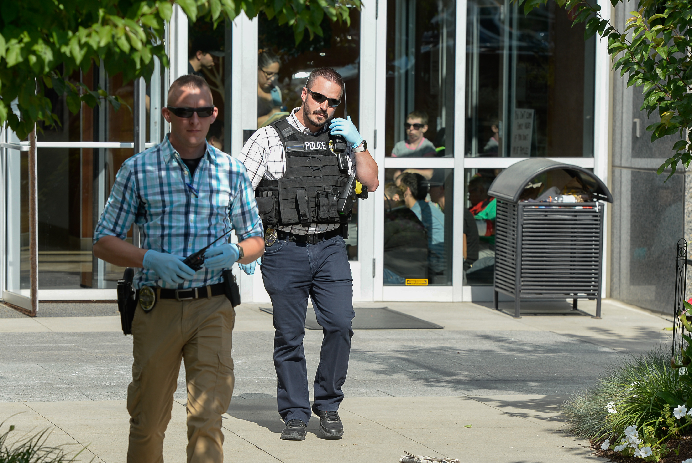 (Francisco Kjolseth | The Salt Lake Tribune) Activists stage a protest against a private prison company with contracts to hold undocumented immigrants on Thursday, July 12, 2018, after locking themselves in the lobby at the headquarters of Management and Training Corporation in Centerville.