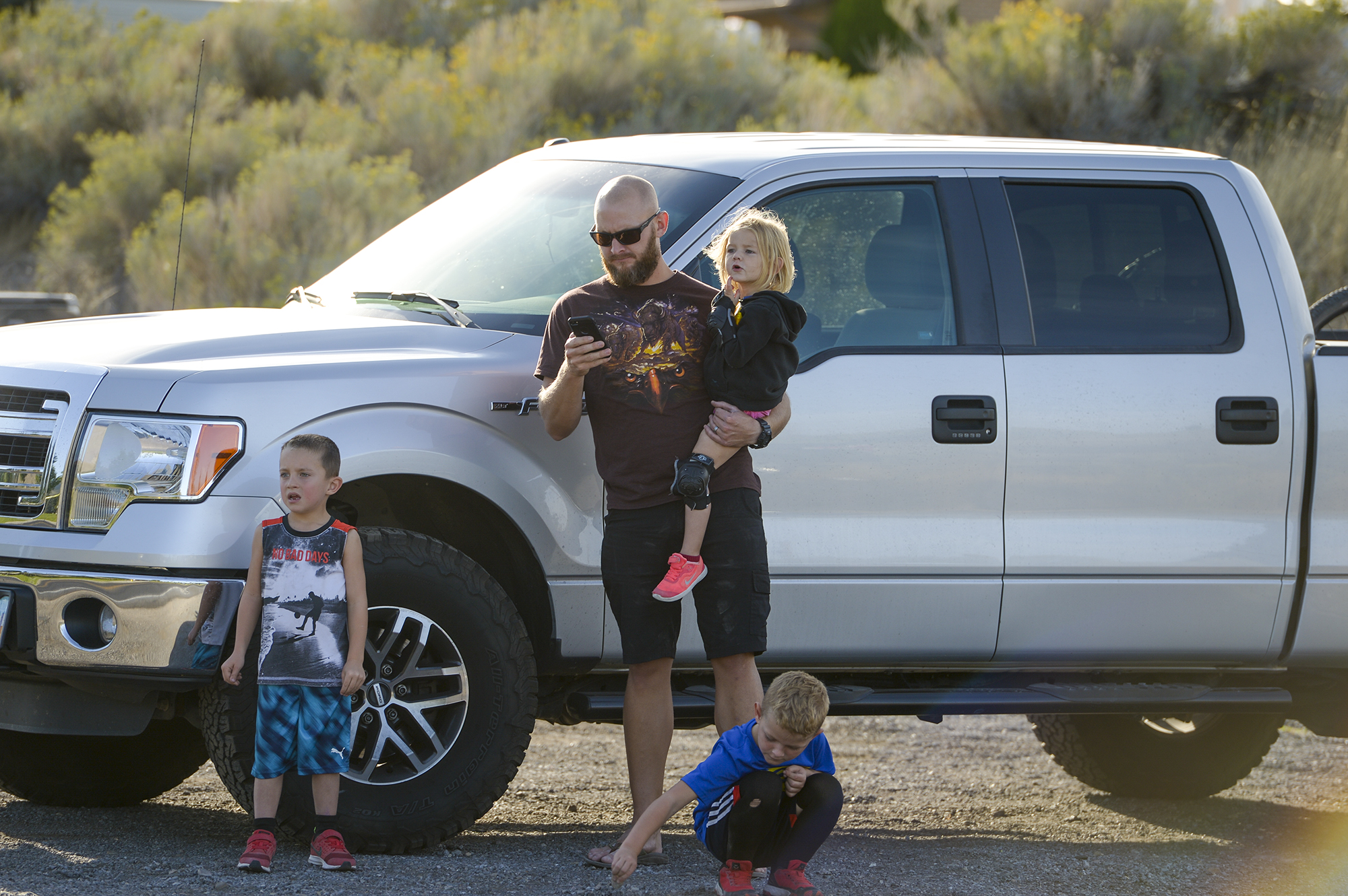 Leah Hogsten | The Salt Lake Tribune Danny Hill and his children l-r Zac, 6, Owen, 5, and Leah, 2, watch as a helicopter gets water from Herriman Cove pond and wait for mom to call them home for dinner. Homeowners who were not allowed to return to their homes and onlookers waited near Herriman Cove pond to watch as a firefighting helicopter refilled. A 50-acre wildfire in Rose Canyon was threatened about a half-dozen homes Wednesday, Sept. 12, 2018. A spokesman for Unified Fire said the blaze has already burned a few structures, including outhouses and sheds. Firefighters have evacuated around 20 to 30 homes in two neighborhoods near 15555 S. Rose Canyon Road in Herriman. 