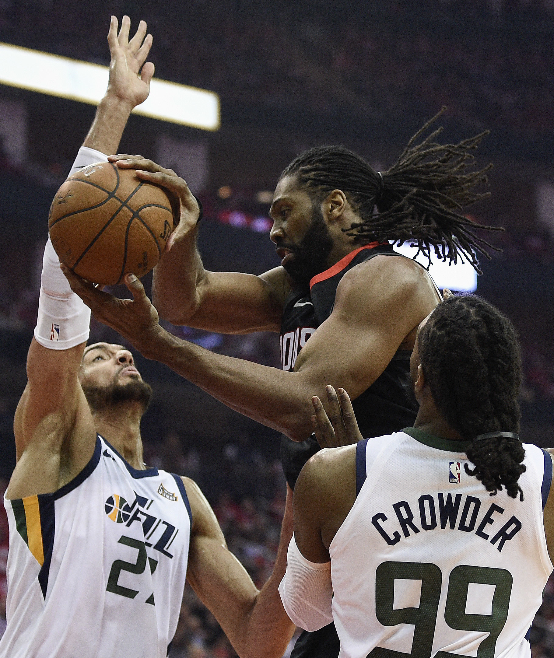 Houston Rockets center Nene Hilario, center, looks to pass as Utah Jazz center Rudy Gobert, left, and forward Jae Crowder (99) defend during the first half in Game 2 of an NBA basketball second-round playoff series Wednesday, May 2, 2018, in Houston. (AP Photo/Eric Christian Smith)