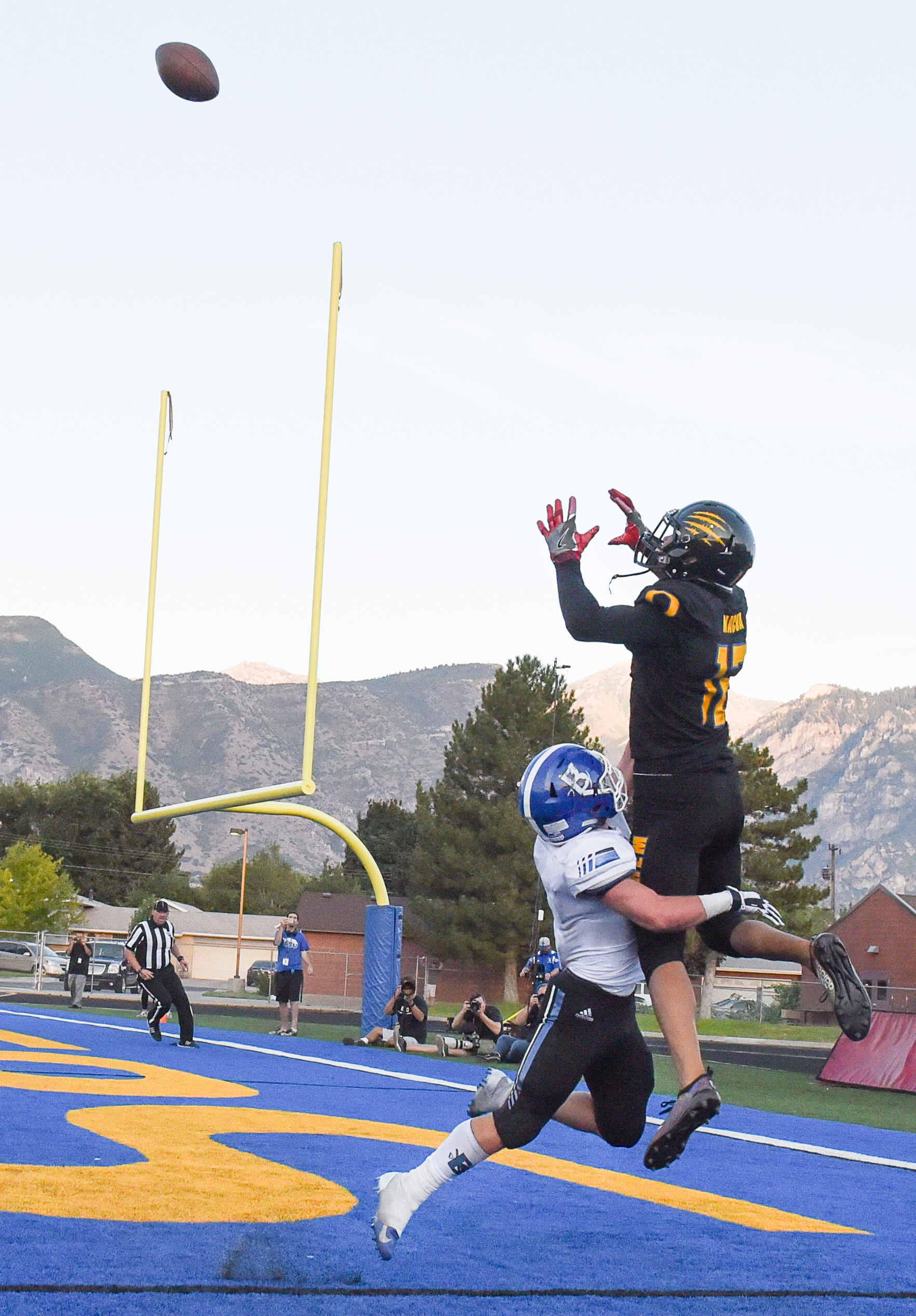 (Francisco Kjolseth | The Salt Lake Tribune) Orem's Puka Nacua pulls in a touchdown pass over Braedon Wissler of Bingham in the first half of the game in Orem, Thursday, Aug. 16, 2018.