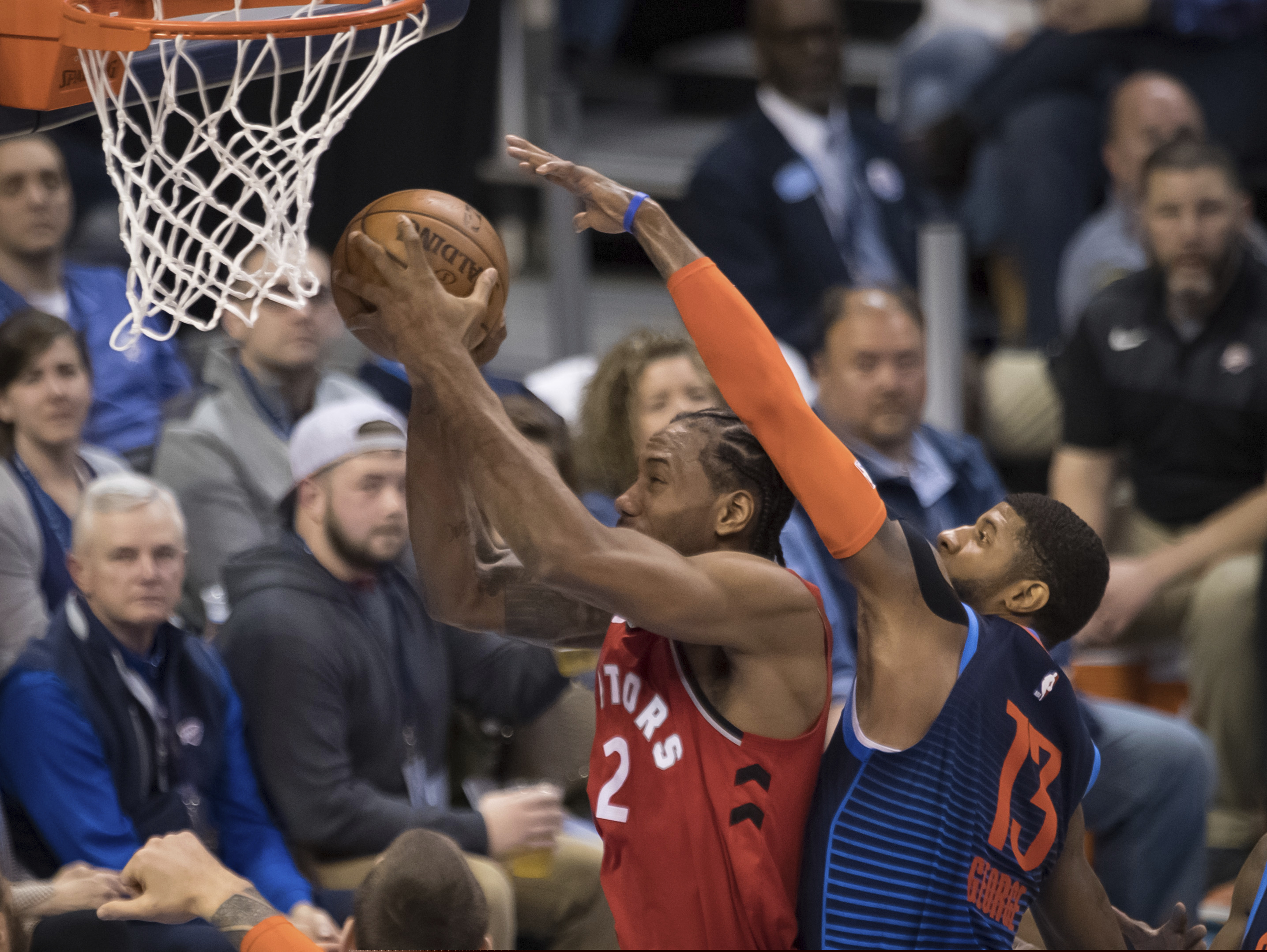 Toronto Raptors forward Kawhi Leonard (2) shoots while defended by Oklahoma City Thunder forward Paul George (13) during the first half of an NBA basketball game Wednesday, March 20, 2019, in Oklahoma City. (AP Photo/Rob Ferguson)