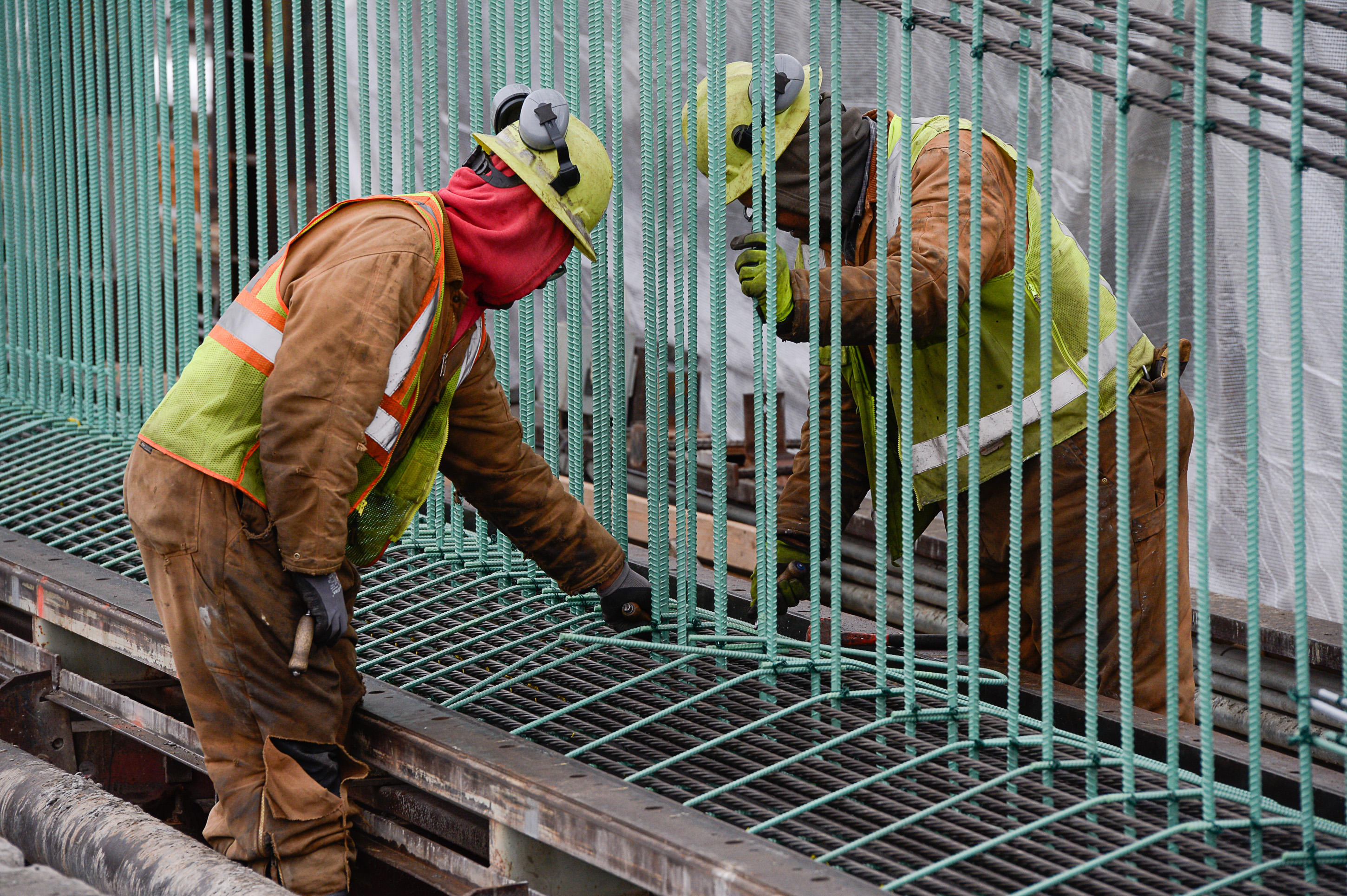 (Francisco Kjolseth | The Salt Lake Tribune) Crew members Meli Kaufausi, left, and Simone Katoa work on the extensive structural integrity of a bridge beam at Forterra Structural Precast in Kearns on Tuesday, Dec. 11, 2018. UDOT is in the process of placing some of the world's largest-ever bridge beams, with the same design, along the technology corridor in Lehi later this week.