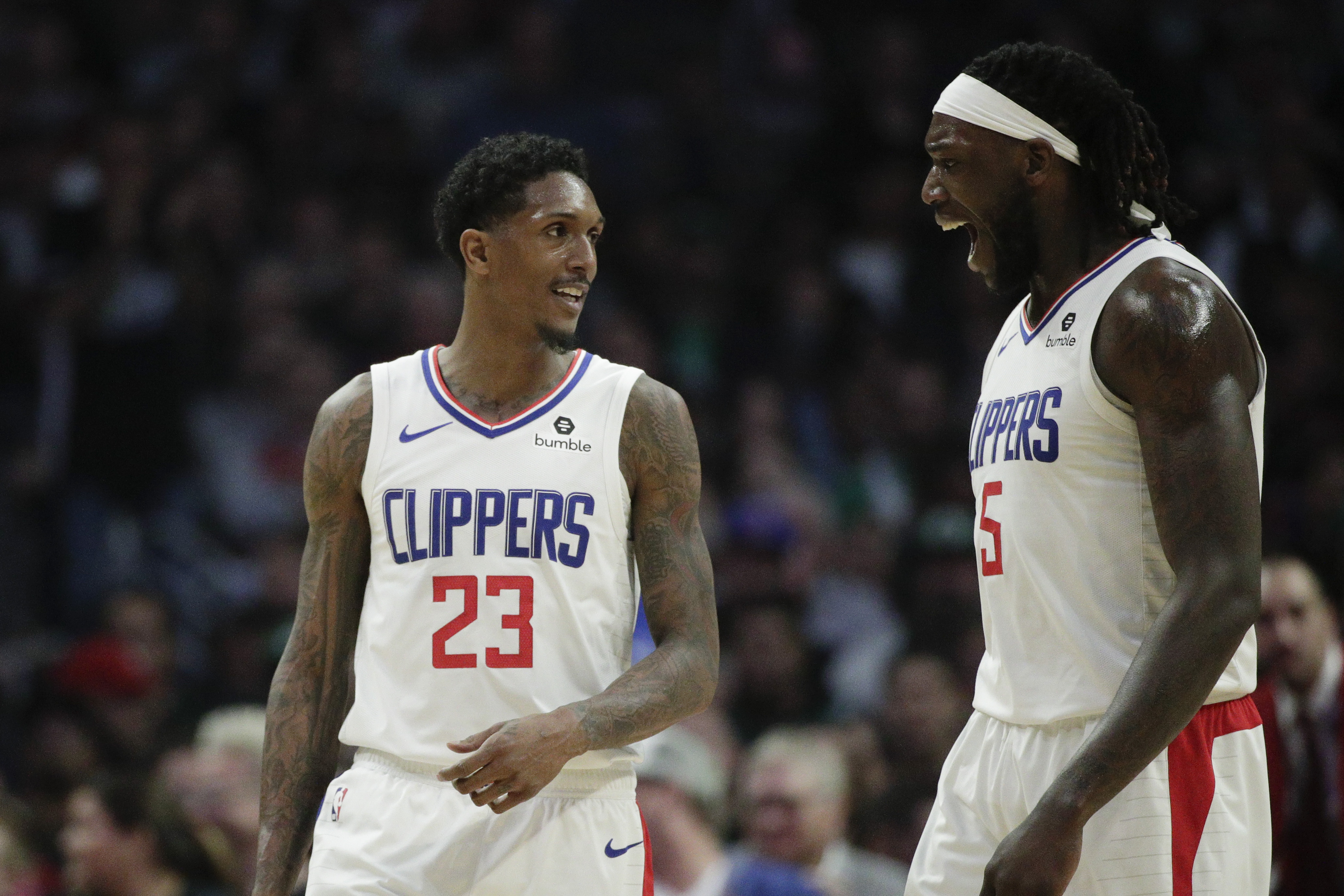 Los Angeles Clippers' Lou Williams, left, and Montrezl Harrell celebrate a basket made by Williams during the second half of an NBA basketball game against the Boston Celtics, Monday, March 11, 2019, in Los Angeles. The Clippers won 140-115. (AP Photo/Jae C. Hong)