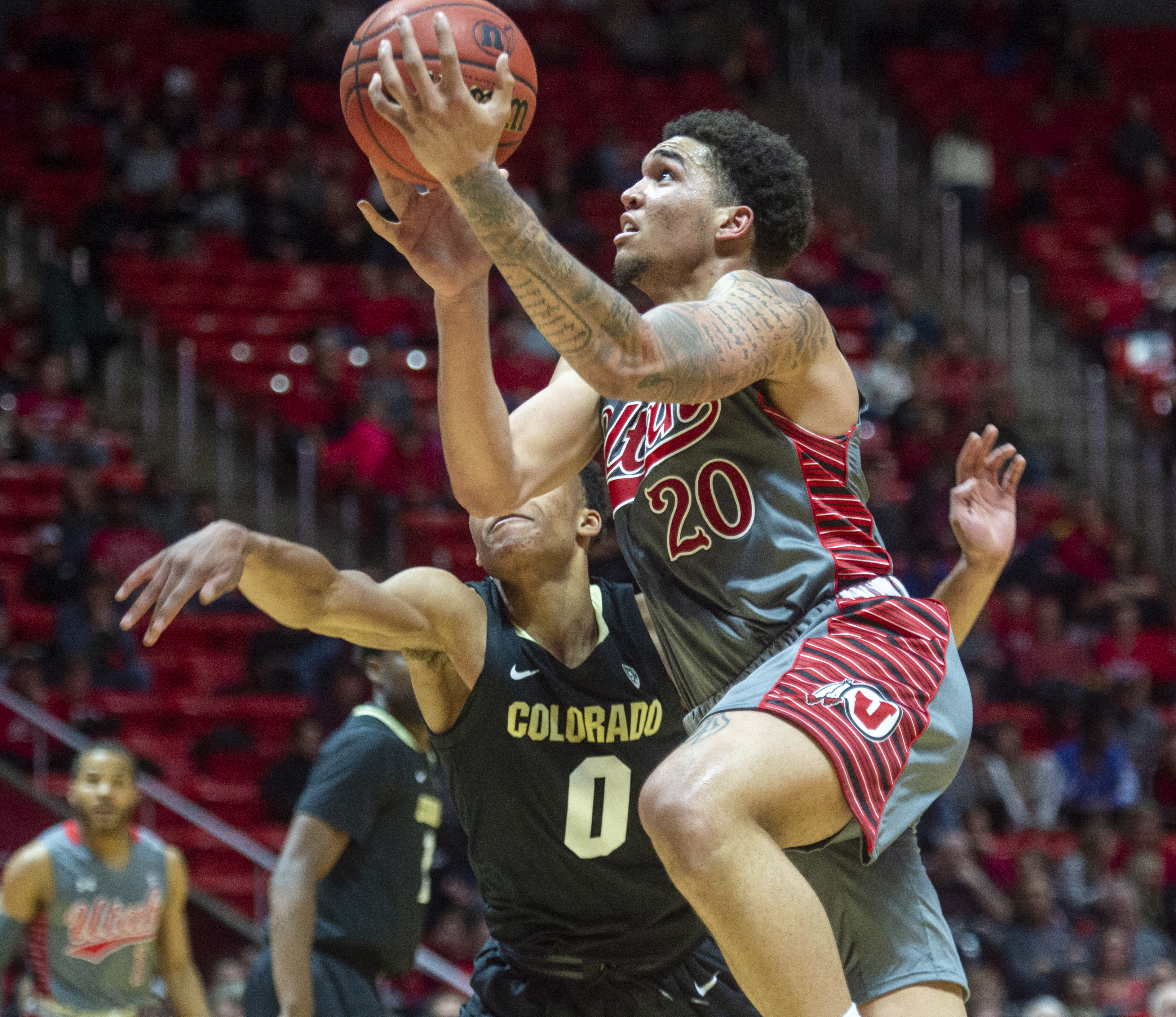 (Rick Egan | The Salt Lake Tribune) Utah Utes forward Timmy Allen (20) goes in for two as Colorado Buffaloes guard Daylen Kountz (2) defends, in PAC-12 basketball action between the Utah Utes and the Colorado Buffaloes at the Jon M. Huntsman Center, Sunday, Jan. 20, 2019. 
