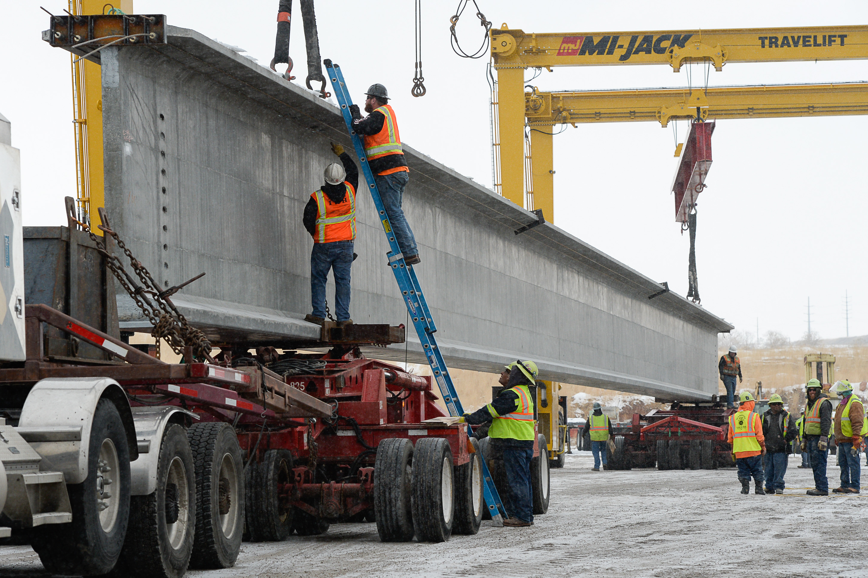 (Francisco Kjolseth | The Salt Lake Tribune) UDOT gets ready to place some of the world's largest-ever bridge beams, and the largest in Utah state history with a span of 203 ft long and just over 8 ft tall, as crews load one on a truck following manufacturing at Forterra Structural Precast in Kearns on Tuesday, Dec. 11, 2018. A total of six beams will be installed in the technology corridor in Lehi later this week.