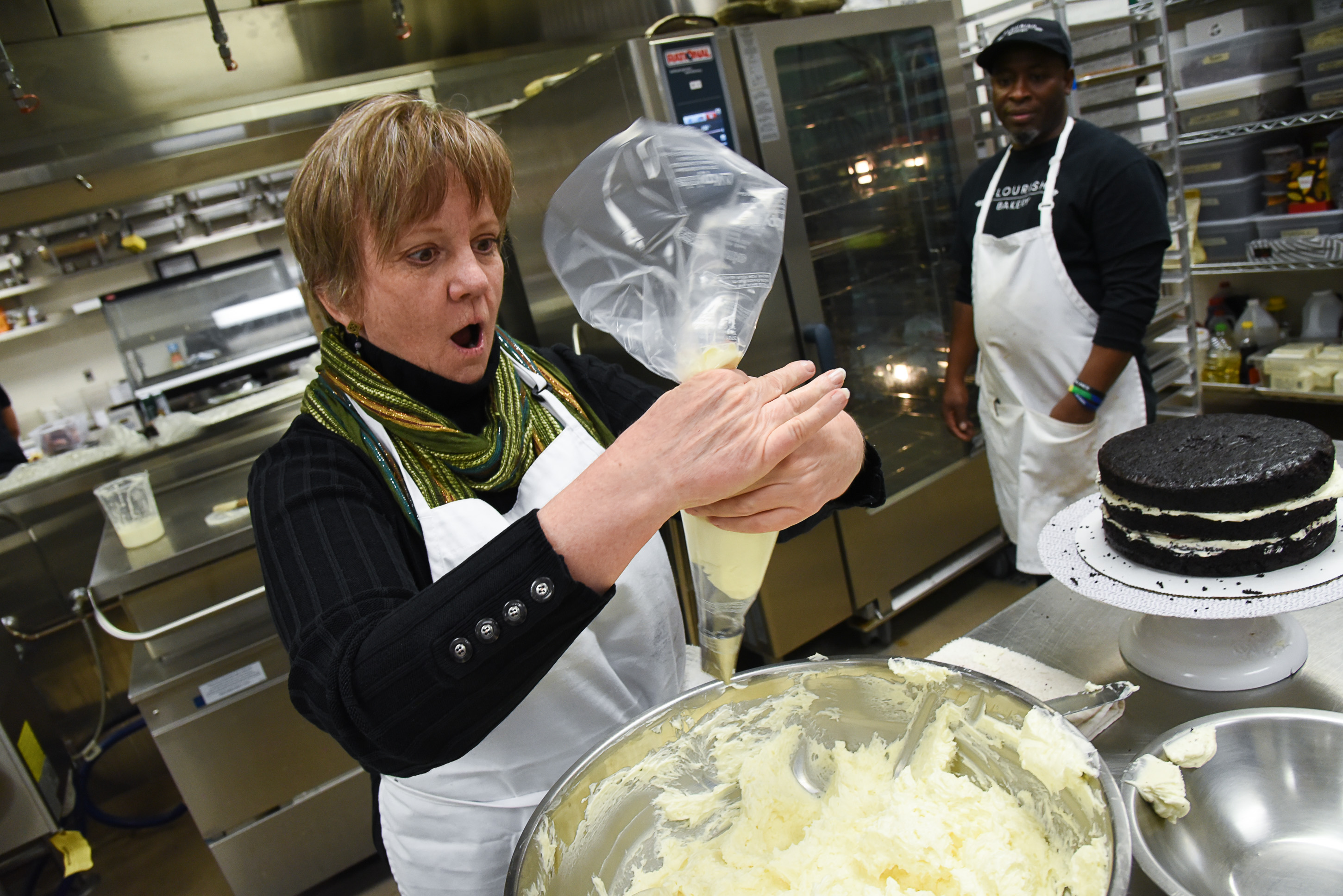 (Francisco Kjolseth | The Salt Lake Tribune) Actress Betsy West has a eureka moment as she understands how to wrap a frosting bag around her thumb as she prepares for an upcoming role of a Southern Baptist bakery owner in North Carolina faced with a request to bake a cake for a gay couple getting married for Salt Lake Acting Company's production of "The Cake." A self admitted baking novice, West, in search of better authenticity in portraying her role received a one-on-one lesson from the chef's at Flourish Bakery.