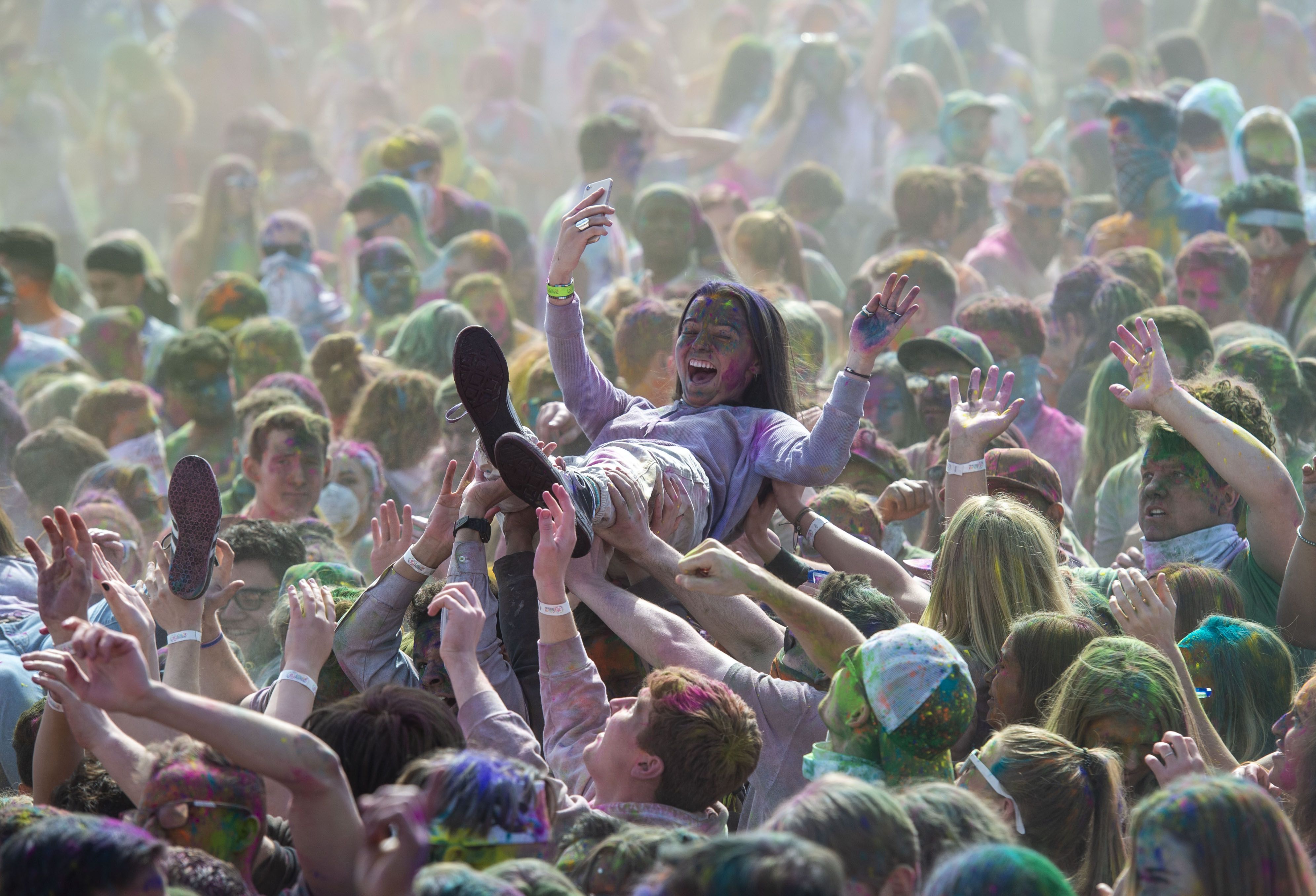 (Rick Egan | The Salt Lake Tribune) Revelers help a friend crowd surf at the Holi Festival of Colors celebration at the Sri Sri Radha Krishna Temple in Spanish Fork, Saturday, March 30, 2019. 