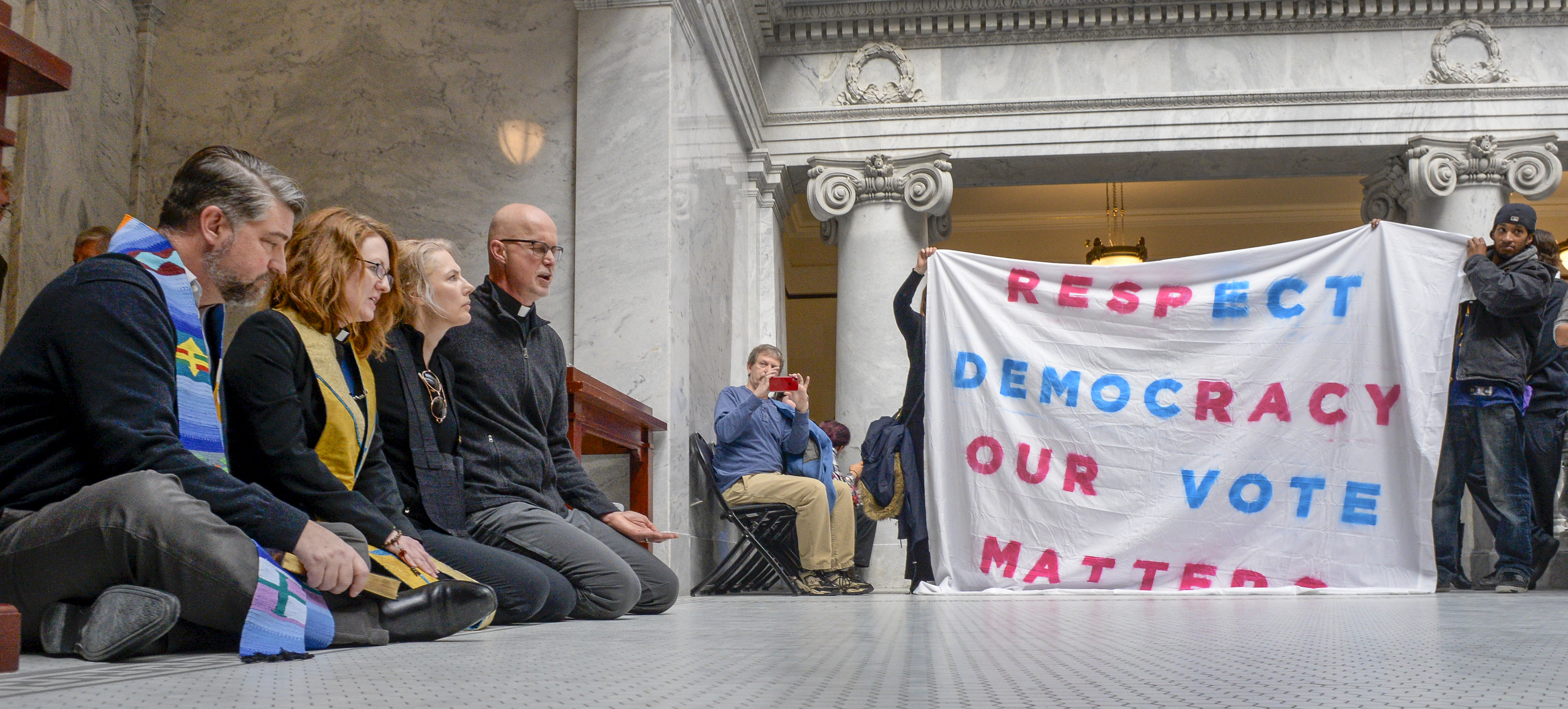 Leah Hogsten | The Salt Lake Tribune Faith leaders l-r Rev. Curtis Price with The First Baptist Church of Salt Lake City, Rev. Monica Dobbins with the First Unitarian Church of Salt Lake City, Zen Buddhist Anna Zumwalt and Pastor David Nichols with Mt. Tabor Lutheran Church demonstrate in opposition to SB96 outside the Utah House chambers, Feb. 8, 2019. 
