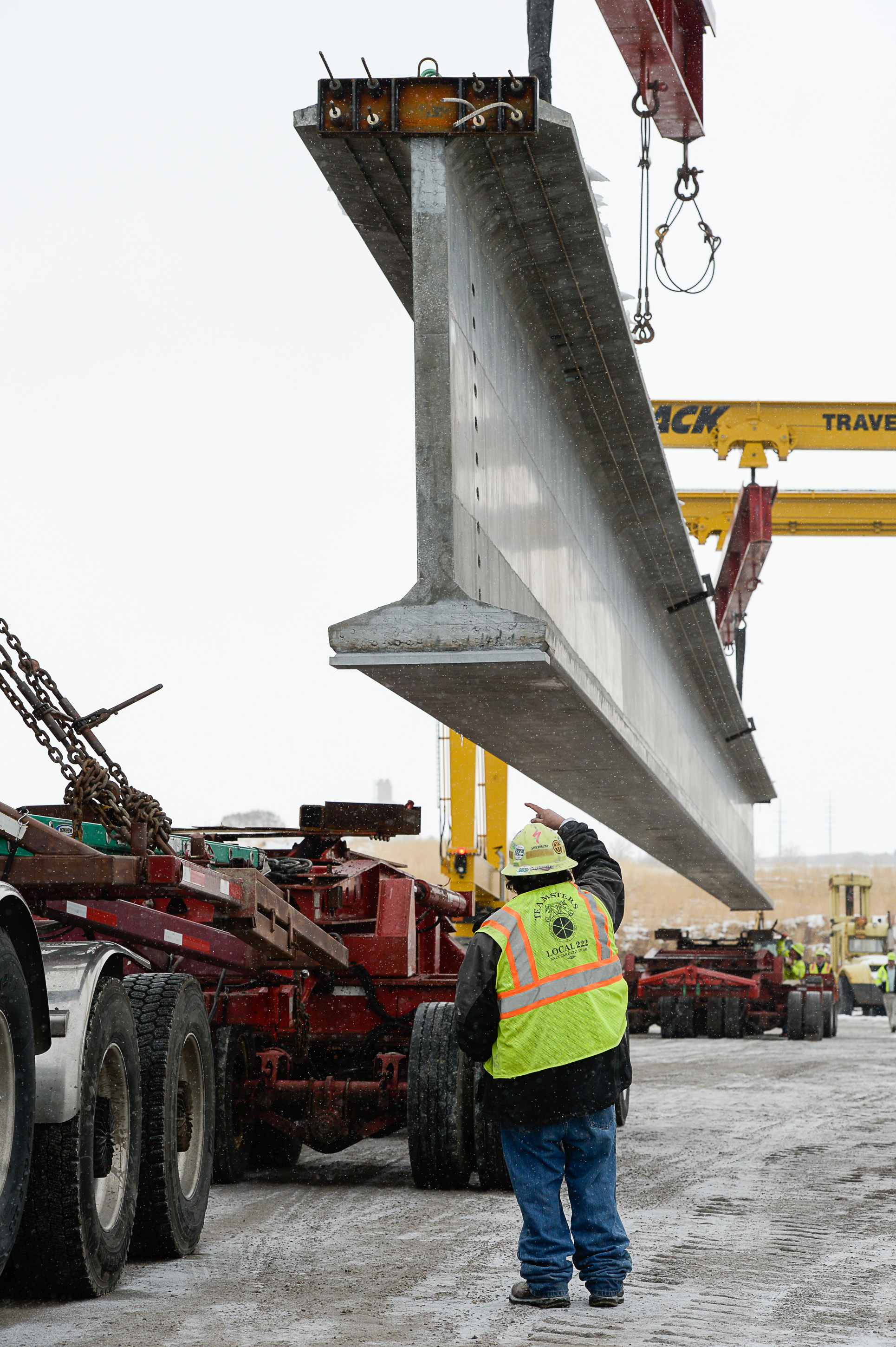 (Francisco Kjolseth | The Salt Lake Tribune) UDOT gets ready to place some of the world's largest-ever bridge beams, and the largest in Utah state history with a span of 203 ft long and just over 8 ft tall, as crews load one on a truck following manufacturing at Forterra Structural Precast in Kearns on Tuesday, Dec. 11, 2018. A total of six beams will be installed in the technology corridor in Lehi later this week.