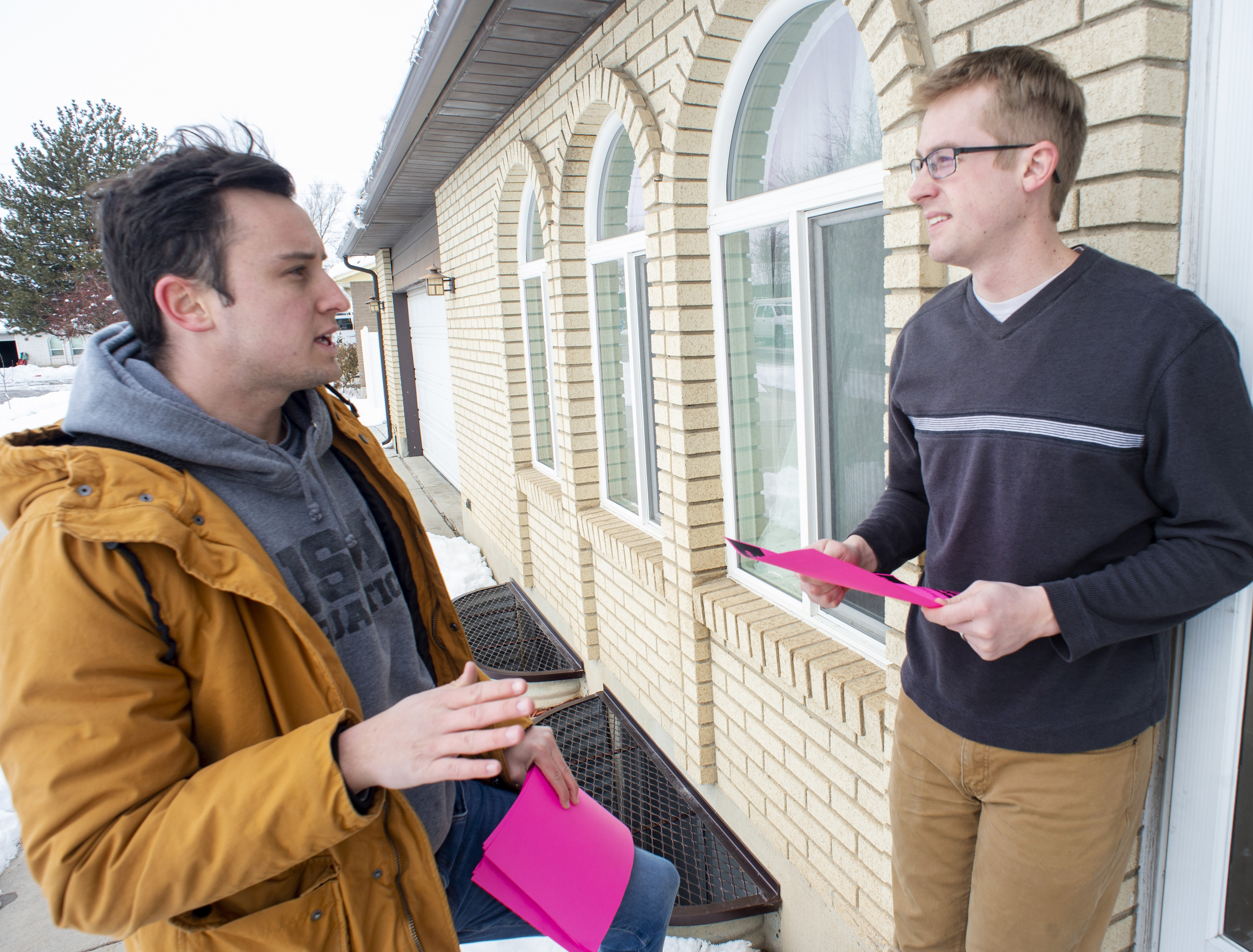 (Rick Egan | The Salt Lake Tribune) Keaton Hill talks to Mark Stacey, as he goes door to door in a neighborhood in Taylorsville with other supporters of the fuller Medicaid expansion, urging residents to call their senator, Saturday, Feb. 9, 2019. 