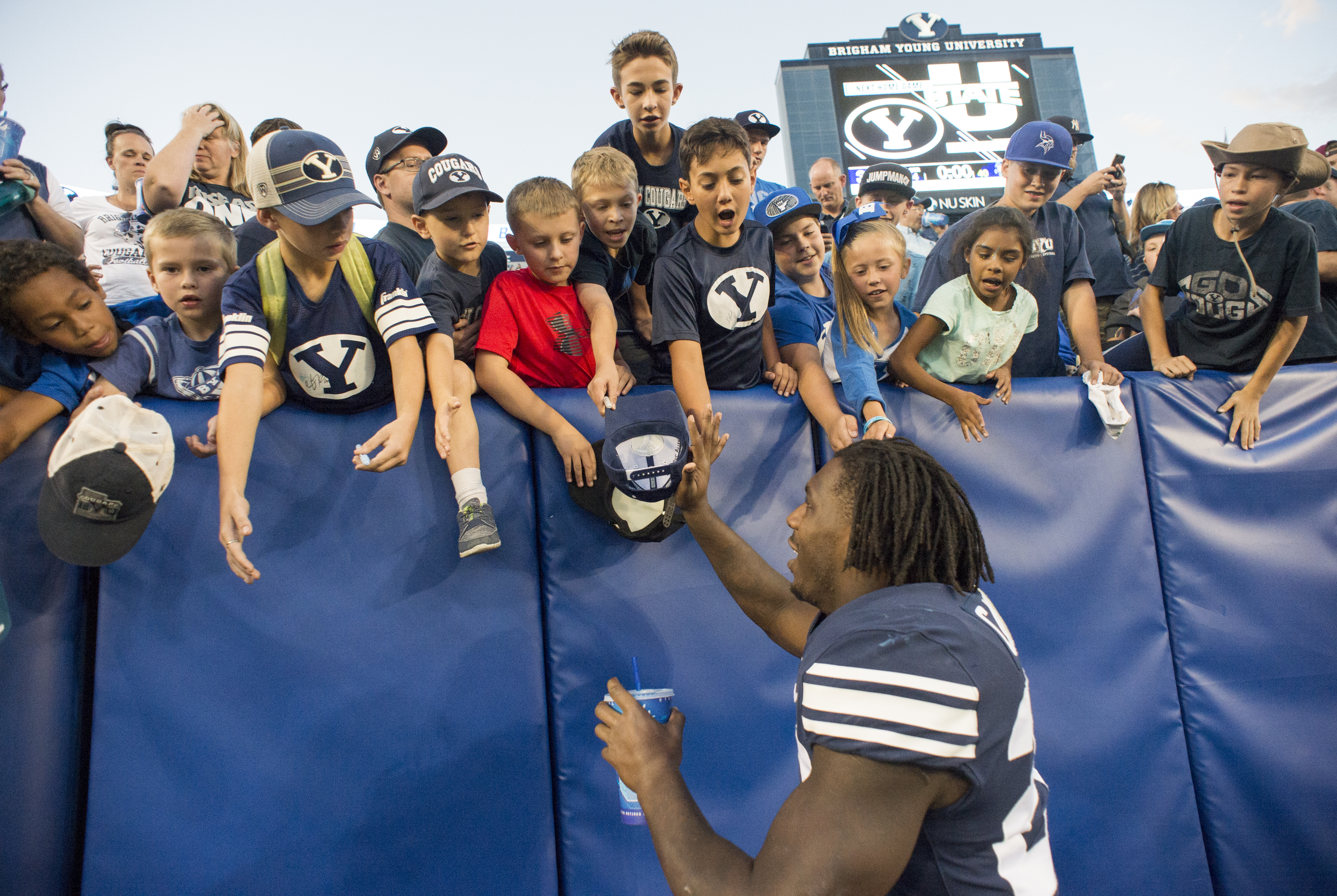 (Rick Egan | The Salt Lake Tribune) Brigham Young Cougars running back Squally Canada (22) high-fives the crowd after the Brigham Young Cougars defeated the McNeese State Cowboys 30-3, at Lavell Edwards Stadium, Saturday, Sept. 22, 2018. 