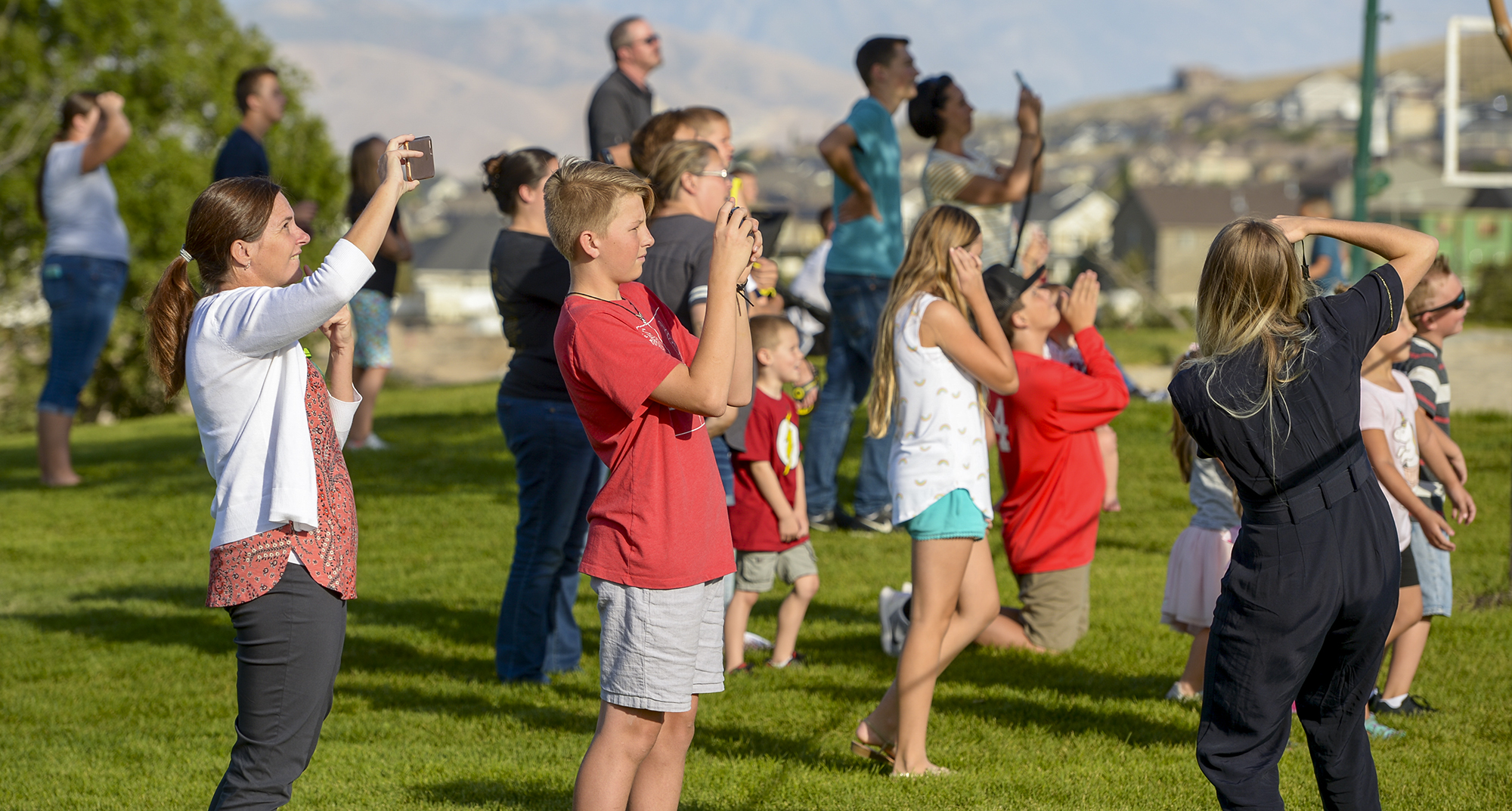 Leah Hogsten | The Salt Lake Tribune Homeowners who were not allowed to return to their homes and onlookers waited near Herriman Cove pond to watch as a firefighting helicopter refilled. A 50-acre wildfire in Rose Canyon was threatened about a half-dozen homes Wednesday, Sept. 12, 2018. A spokesman for Unified Fire said the blaze has already burned a few structures, including outhouses and sheds. Firefighters have evacuated around 20 to 30 homes in two neighborhoods near 15555 S. Rose Canyon Road in Herriman. 