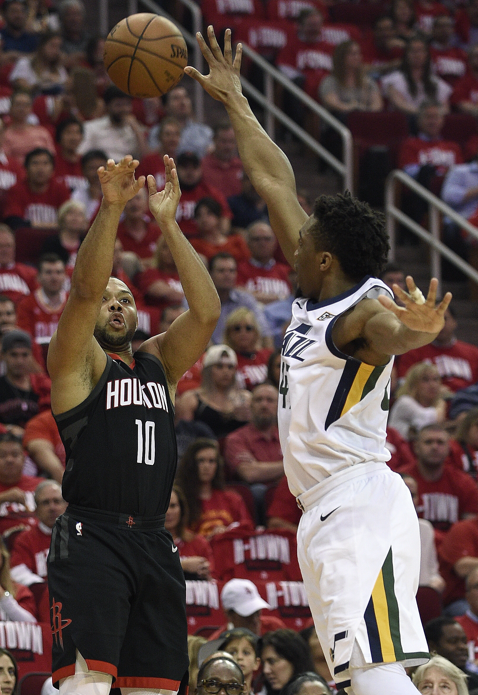 Houston Rockets guard Eric Gordon (10) shoots as Utah Jazz guard Donovan Mitchell defends during the first half in Game 2 of an NBA basketball second-round playoff series Wednesday, May 2, 2018, in Houston. (AP Photo/Eric Christian Smith)